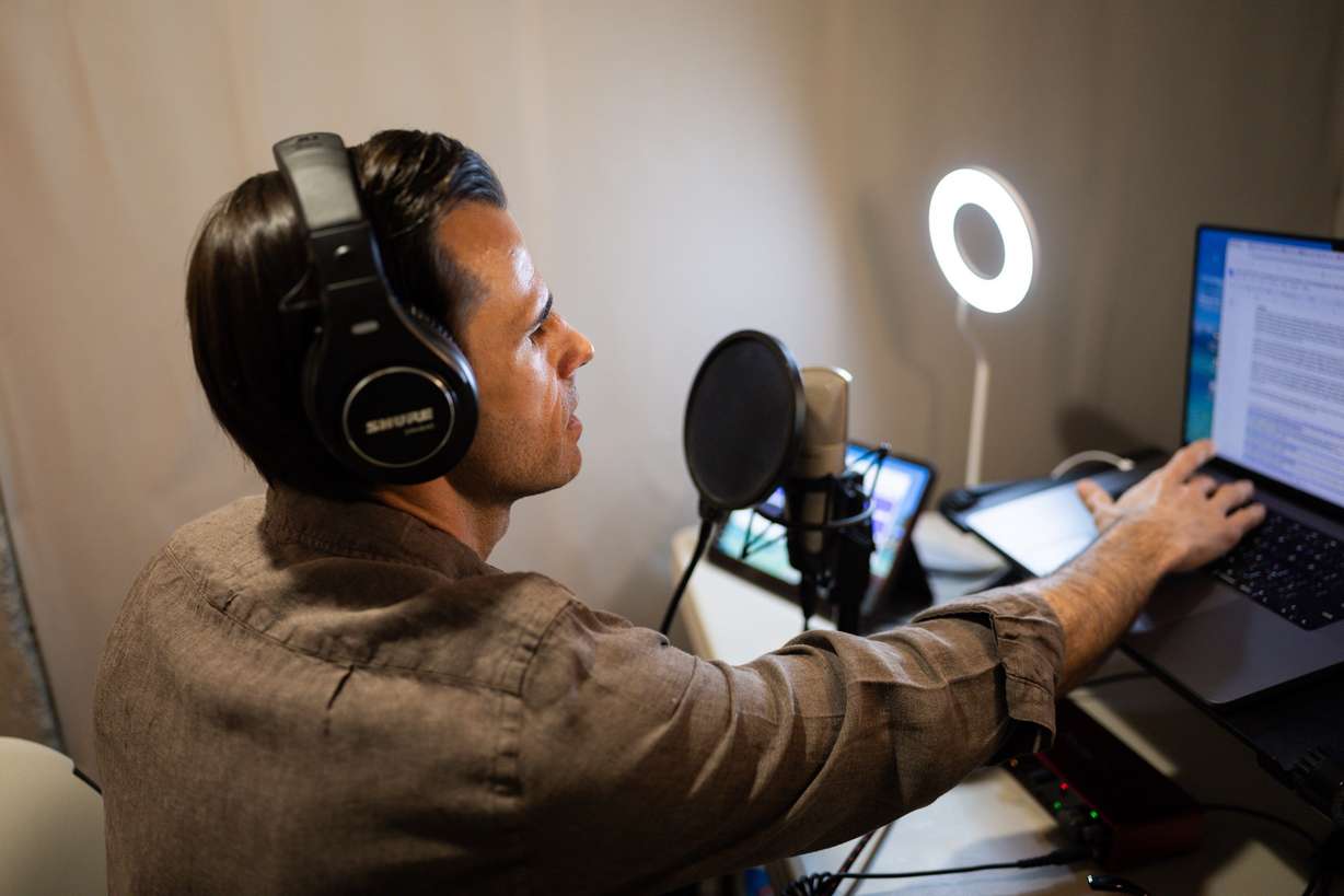 Greg Jackson, a UVU professor, author and podcast host of “History That Doesn’t Suck,” poses in his podcast studio at his home in Lehi on July 9. His new book is “Been There, Done That: How Our History Shows What We Can Overcome.”