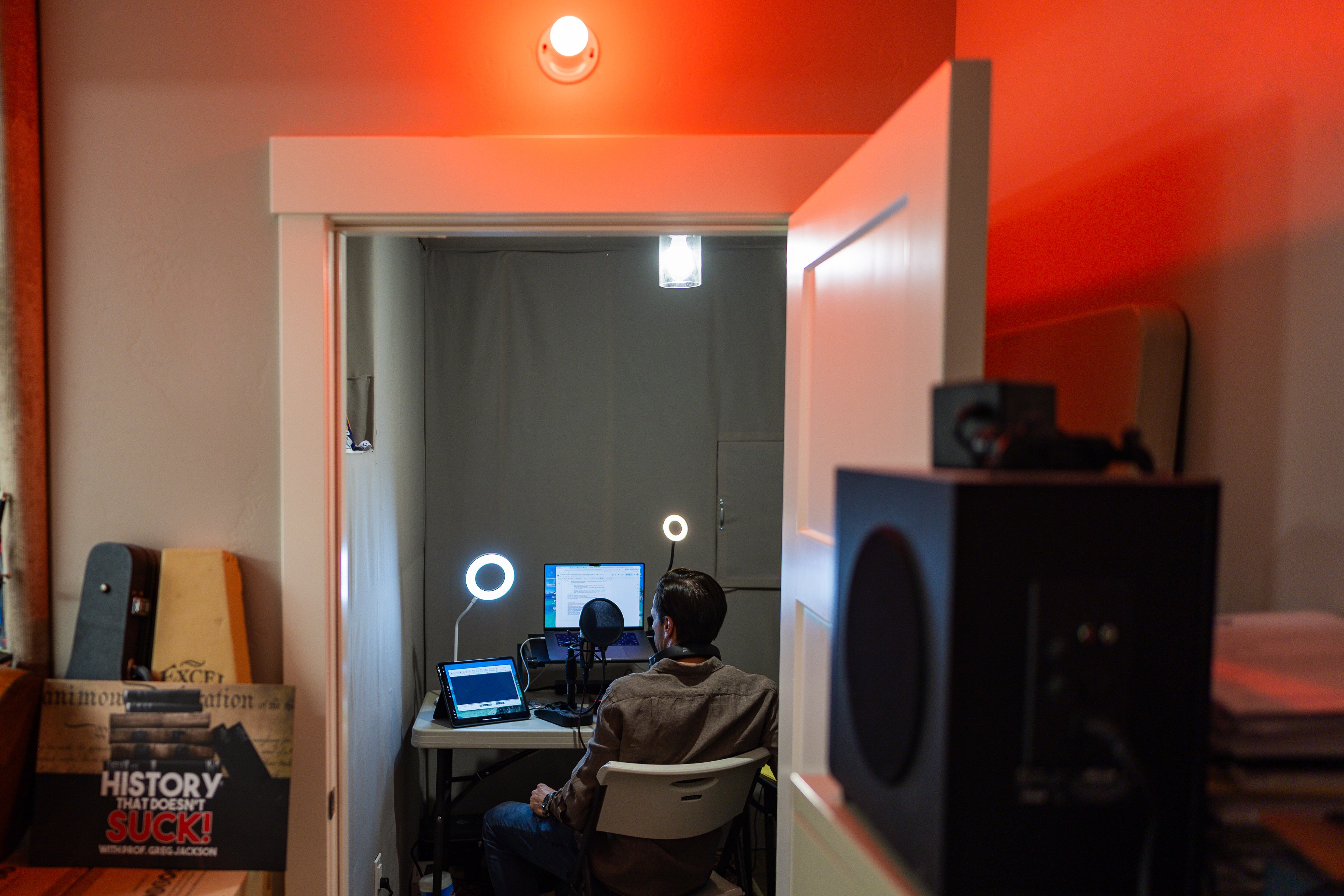 Greg Jackson, a UVU professor, author and podcast host of “History That Doesn’t Suck,” poses in his podcast studio at his home in Lehi on July 9. His new book is “Been There, Done That: How Our History Shows What We Can Overcome.”
