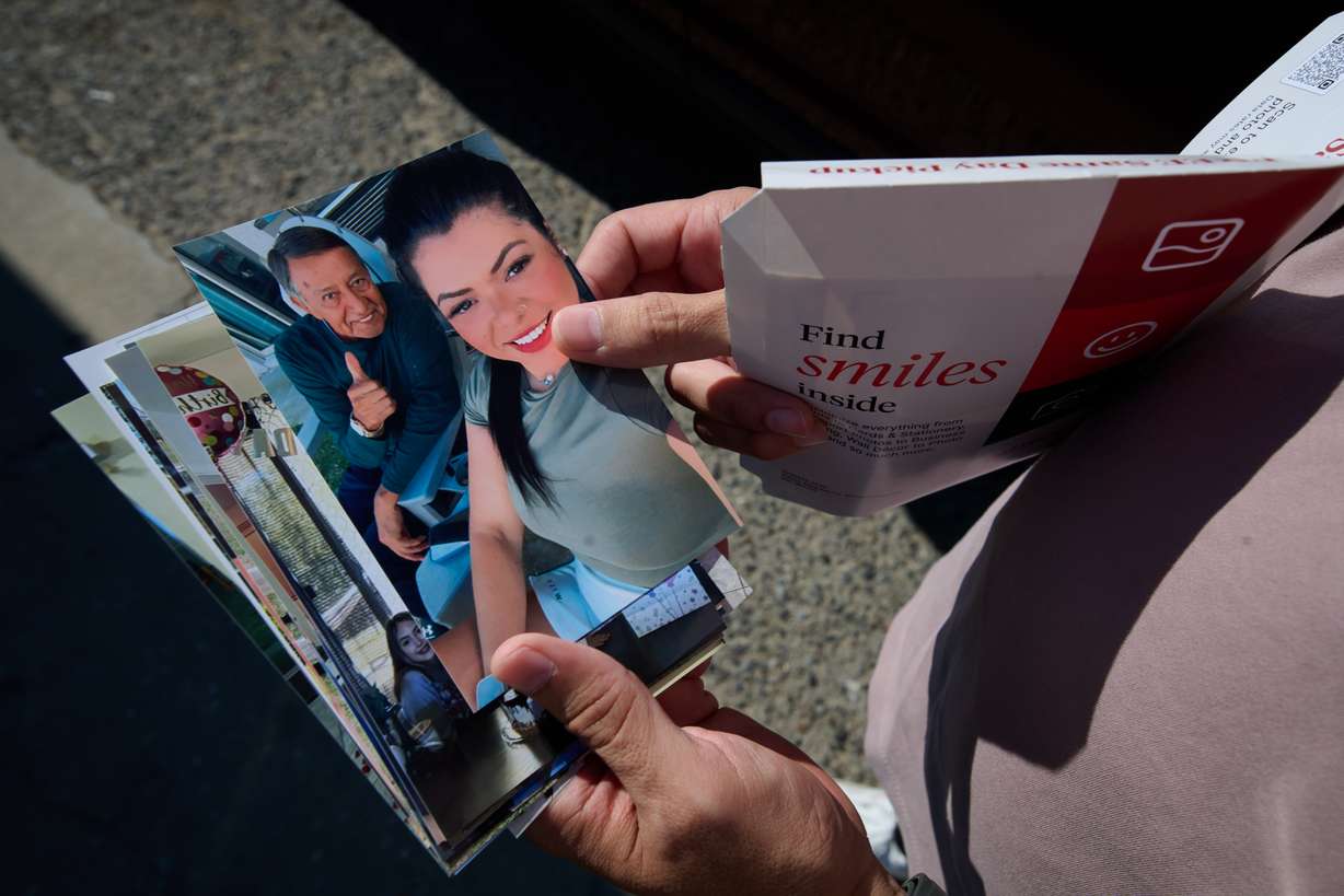 Army Staff Sgt. Alexis Jaramillo shows photos of his wife, Maisa Lopes Eliaser, a Brazilian national who is detained by ICE, near the South Louisiana ICE Processing Center where she is currently held, in Basile, La., Aug. 2.