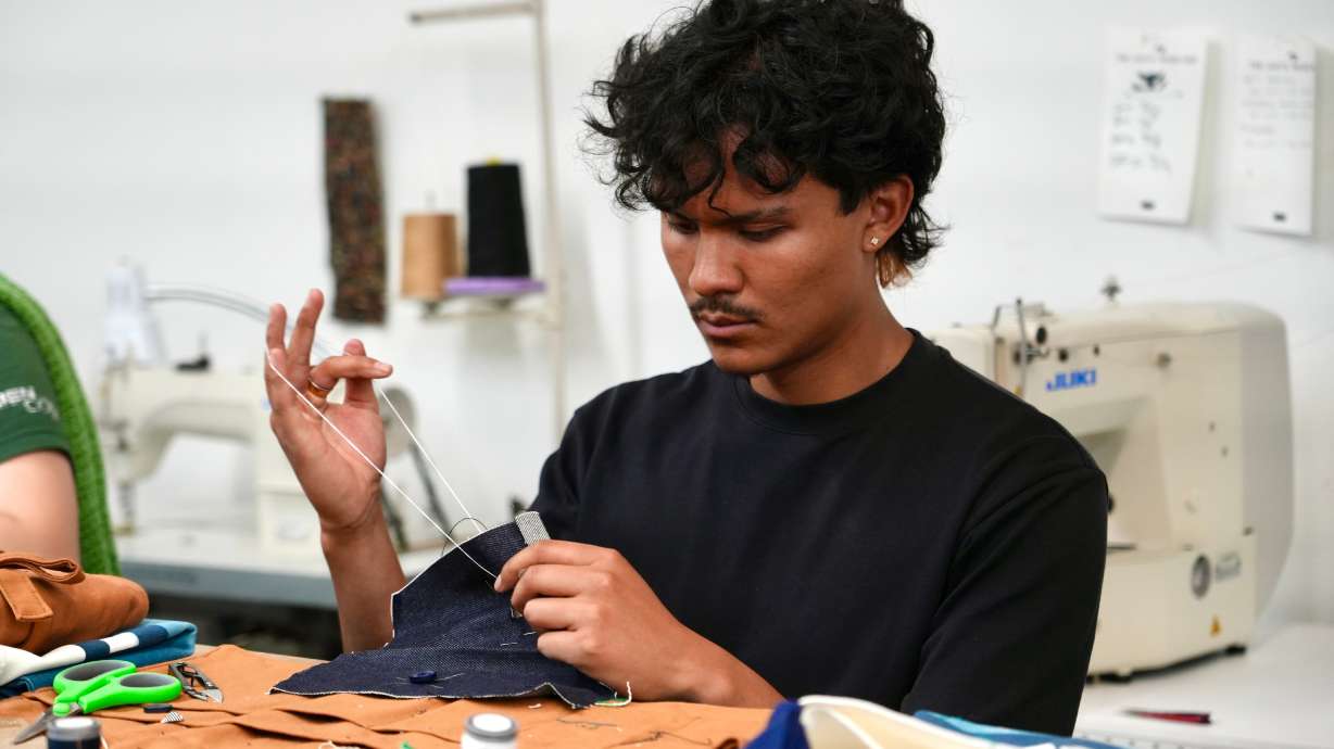 Jesse Sanchez practices sewing during a clothing repair workshop at a Levi's retail store in downtown San Francisco, July 22.