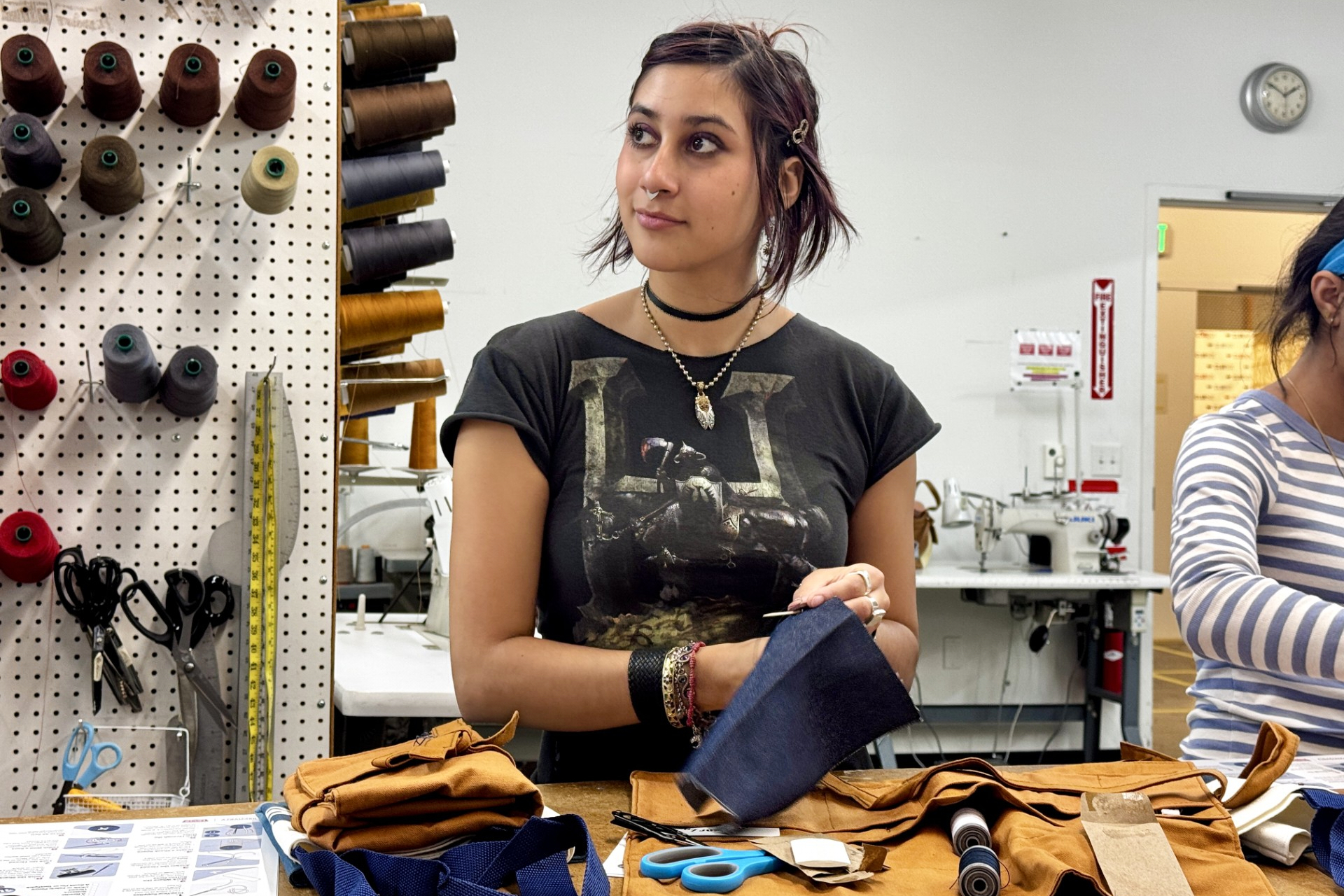 Ava Trujillo practices attends a clothing repair workshop at a Levi's retail store in downtown San Francisco, July 22.