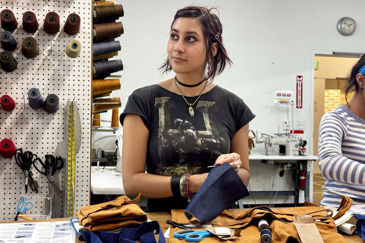 Ava Trujillo practices attends a clothing repair workshop at a Levi's retail store in downtown San Francisco, July 22.