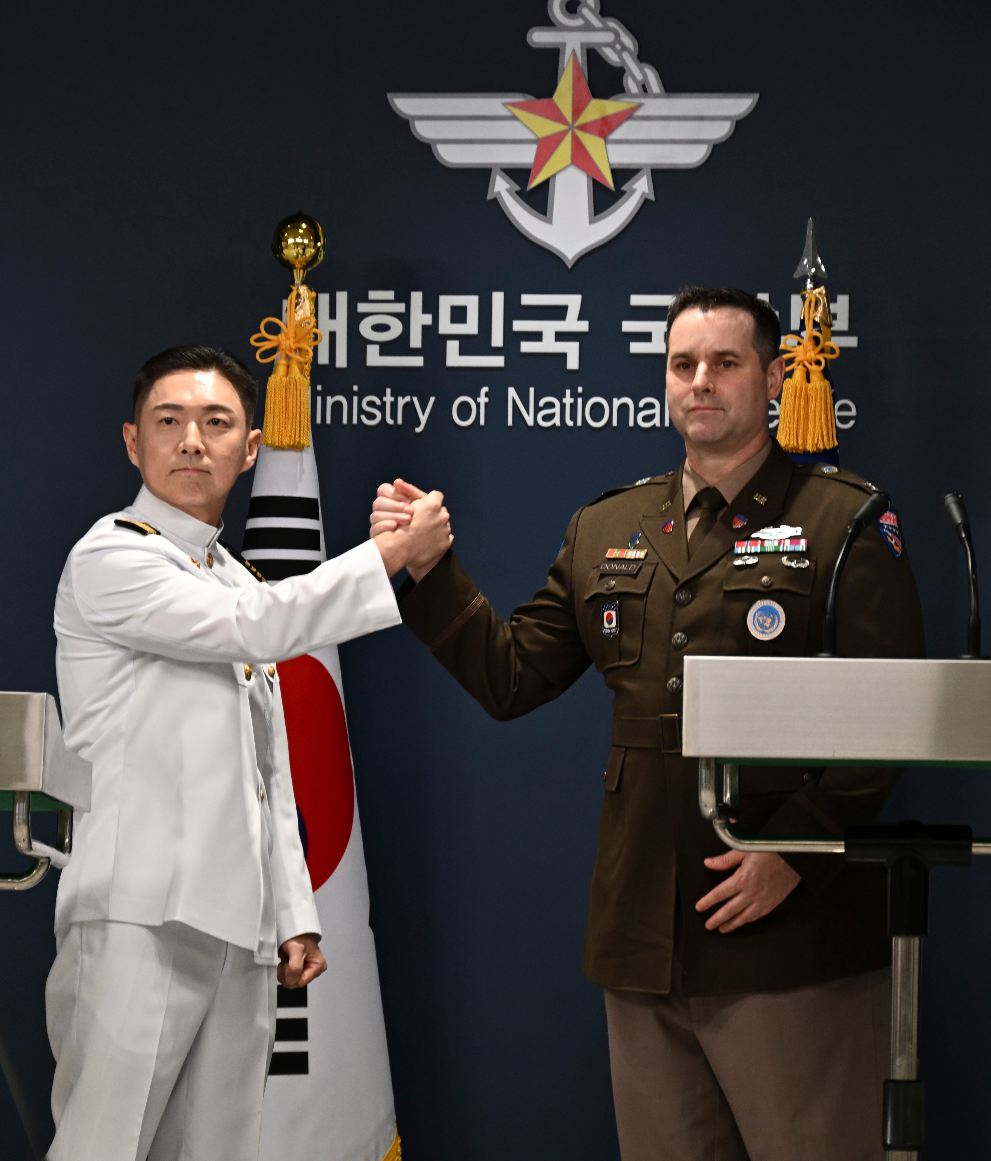 Col. Jang Do-young, left, public affairs director of South Korea's Joint Chiefs of Staff, shakes hands with Col. Ryan Donaldn, public affairs director of the United Nations Command, Combined Forces Command and United States Forces Korea during a press briefing for the Ulchi Freedom Shield 2026 exercise at the Defense Ministry in Seoul, South Korea Monday.