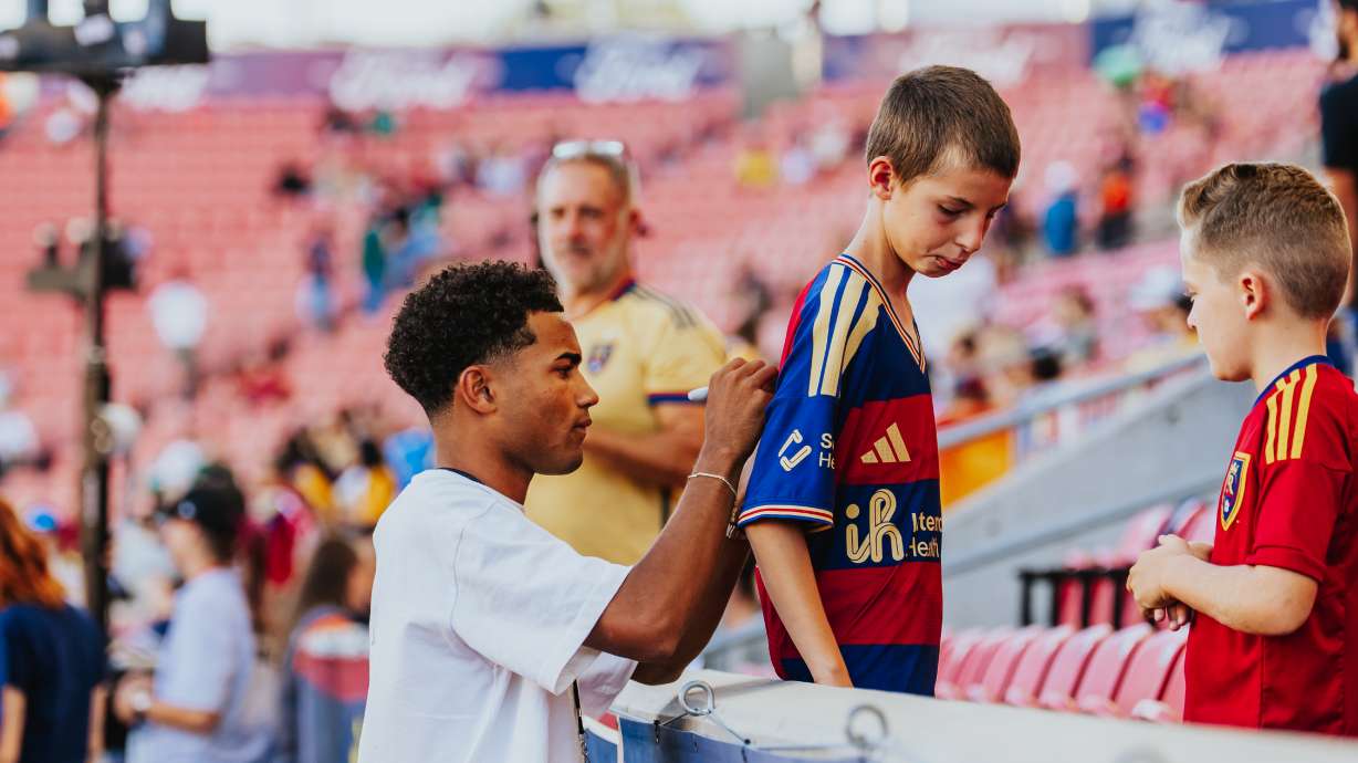 Real Salt Lake winger Zavier Gozo signs autographs for fans before the club's Leagues Cup match against Tigres UANL, Tuesday, Aug. 4, 2026 at America First Field in Sandy, Utah.