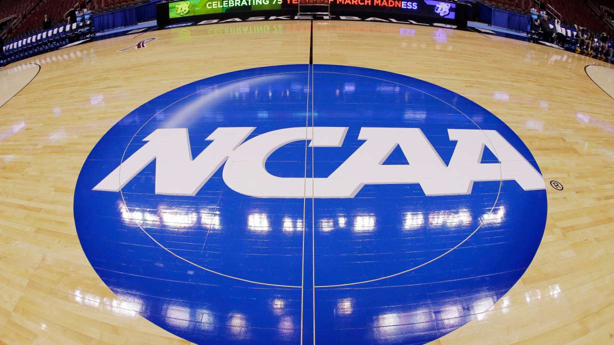 FILE - This photo taken with a fisheye lens shows the NCAA logo displayed at mid-court in Philadelphia, March 21, 2013.