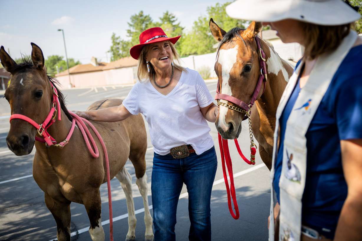 Pastor Sarah Merchant, right, blesses Sandy city mayor Monica Zoltanski’s, center, horses during a Blessing of the Animals in conjunction with the celebration of the Hilltop United Methodist Church’s 125th anniversary at Hilltop United Methodist Church in Sandy on Saturday.