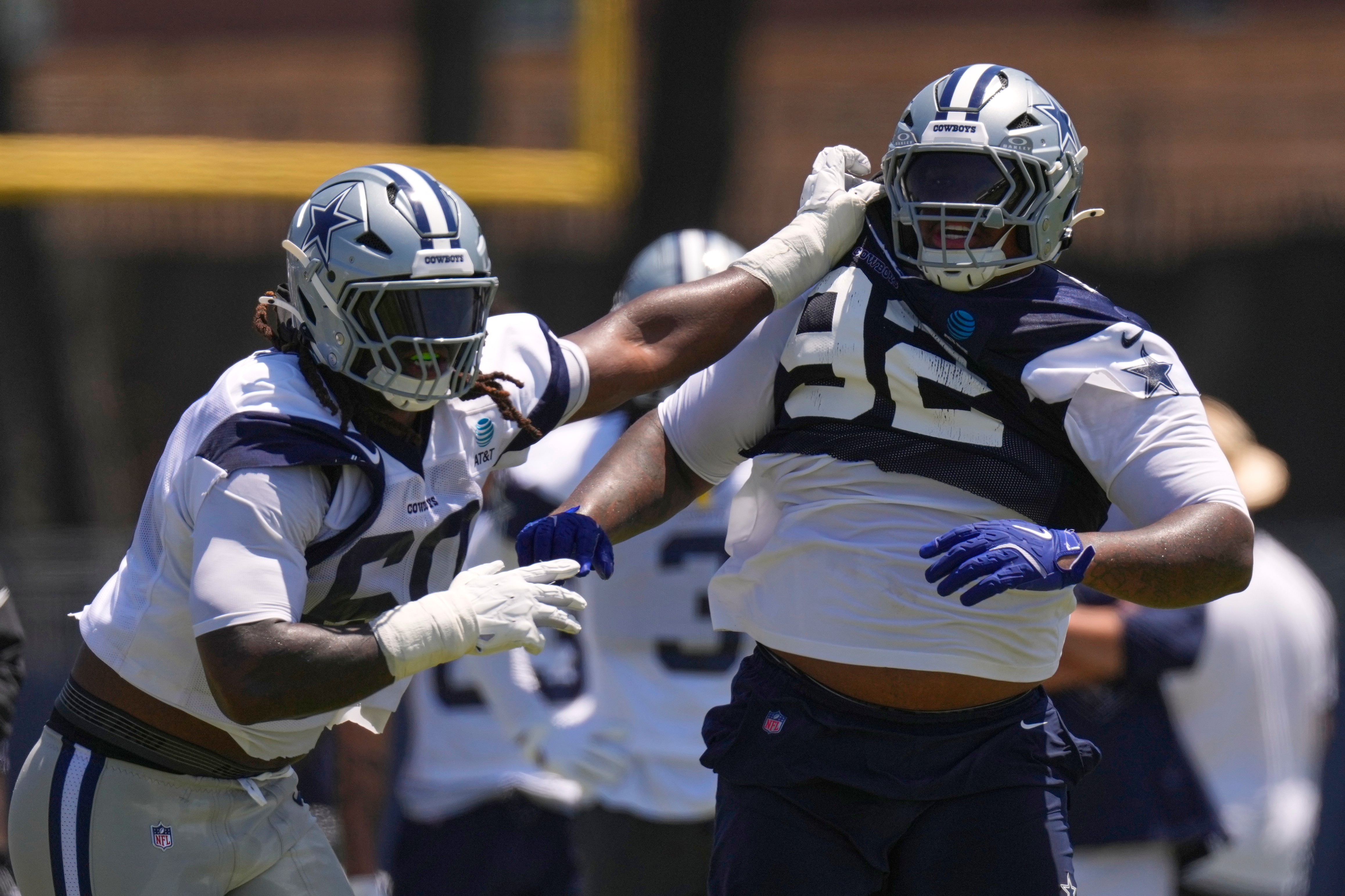 Dallas Cowboys offensive tackle Tyler Guyton, left, holds defensive tackle Quinnen Williams back during the NFL football team's training camp, Saturday, Aug. 1, 2026, in Oxnard, Calif.