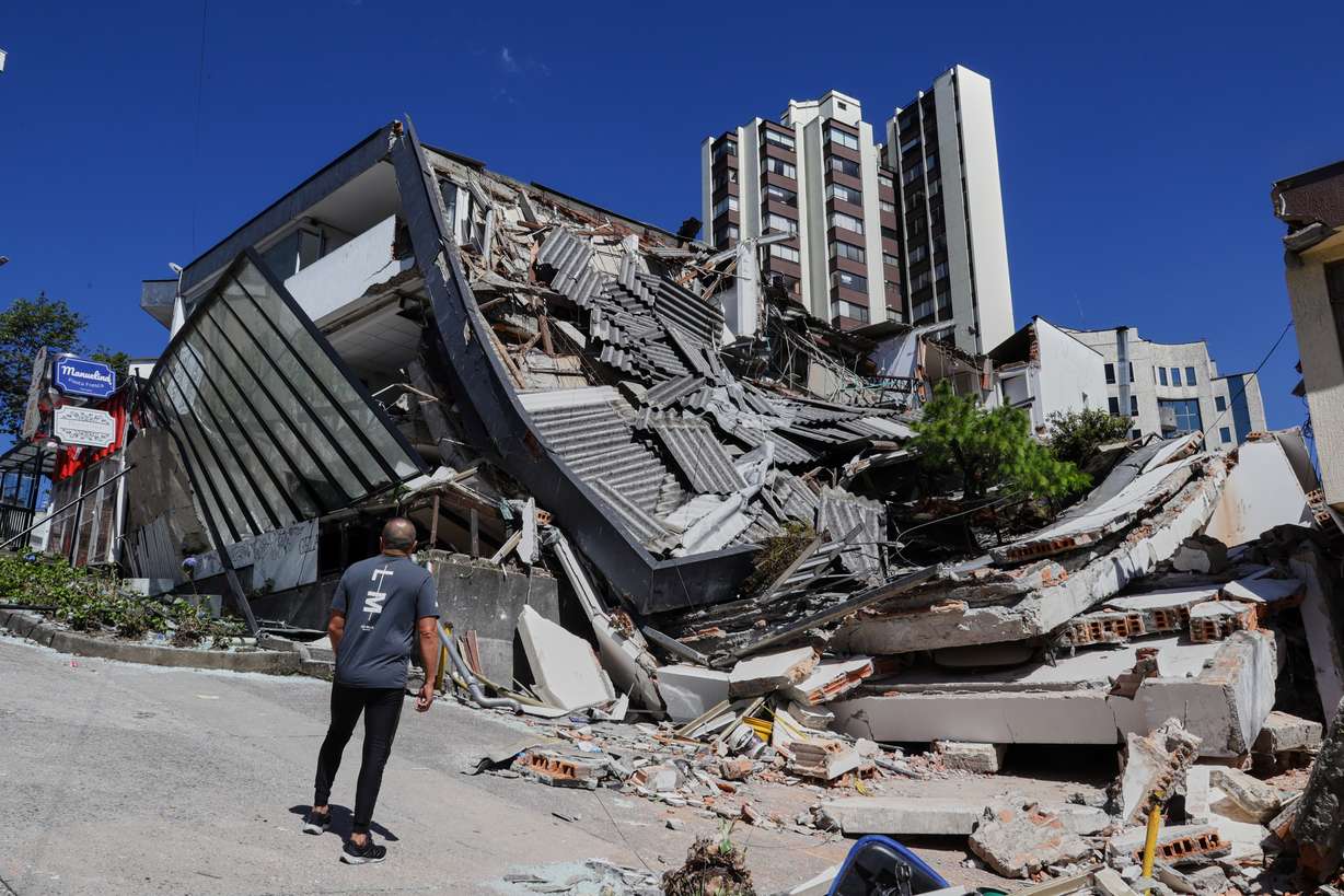 A man looks at a collapsed building after an earthquake struck Manizales, Colombia, Monday.