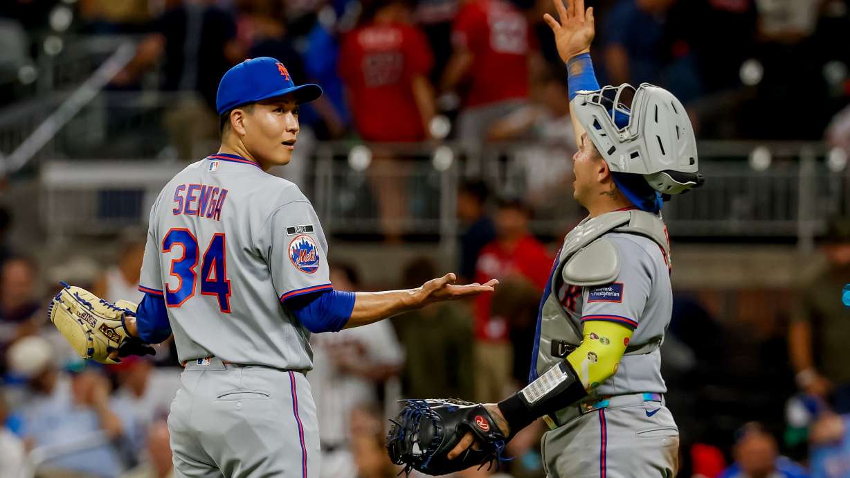 New York Mets pitcher Kodai Senga, left, reacts with catcher Francisco Alvarez, right, after closing out the Atlanta Braves during the ninth inning of a baseball game, Monday, Aug. 10, 2026, in Atlanta.