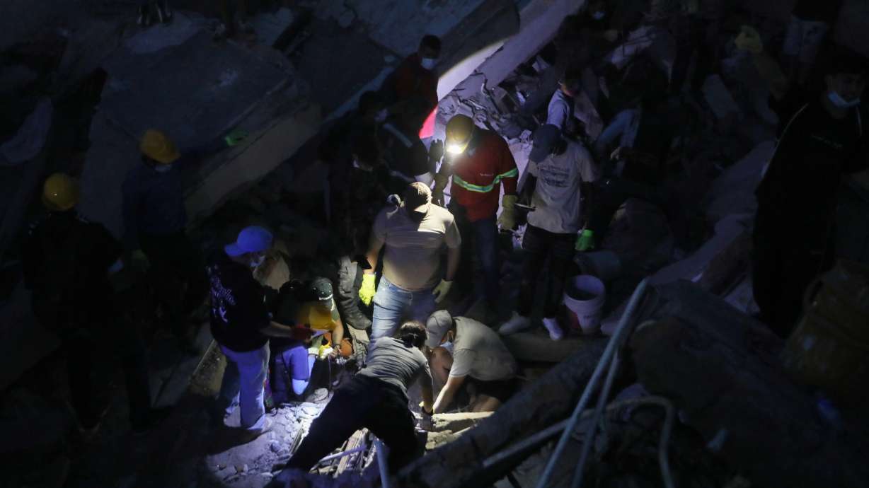 People search through the rubble after an earthquake struck Cali, Colombia, Monday. Search and rescue efforts resumed on Tuesday after a powerful earthquake on Monday left over 3,000 missing and killed at least 181 people.