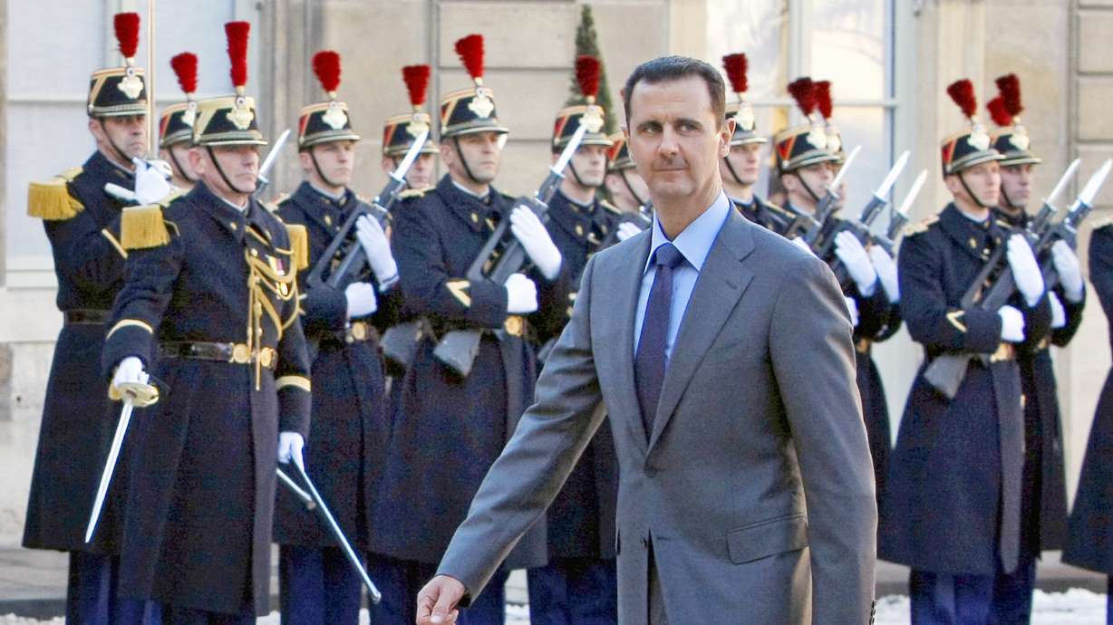 Syria President Bashar al-Assad arrives at the Elysee Palace in Paris for his meeting with then-French President Nicolas Sarkozy, Dec. 9, 2010. Al-Assad and his brother were sentenced to death in absentia on Tuesday.