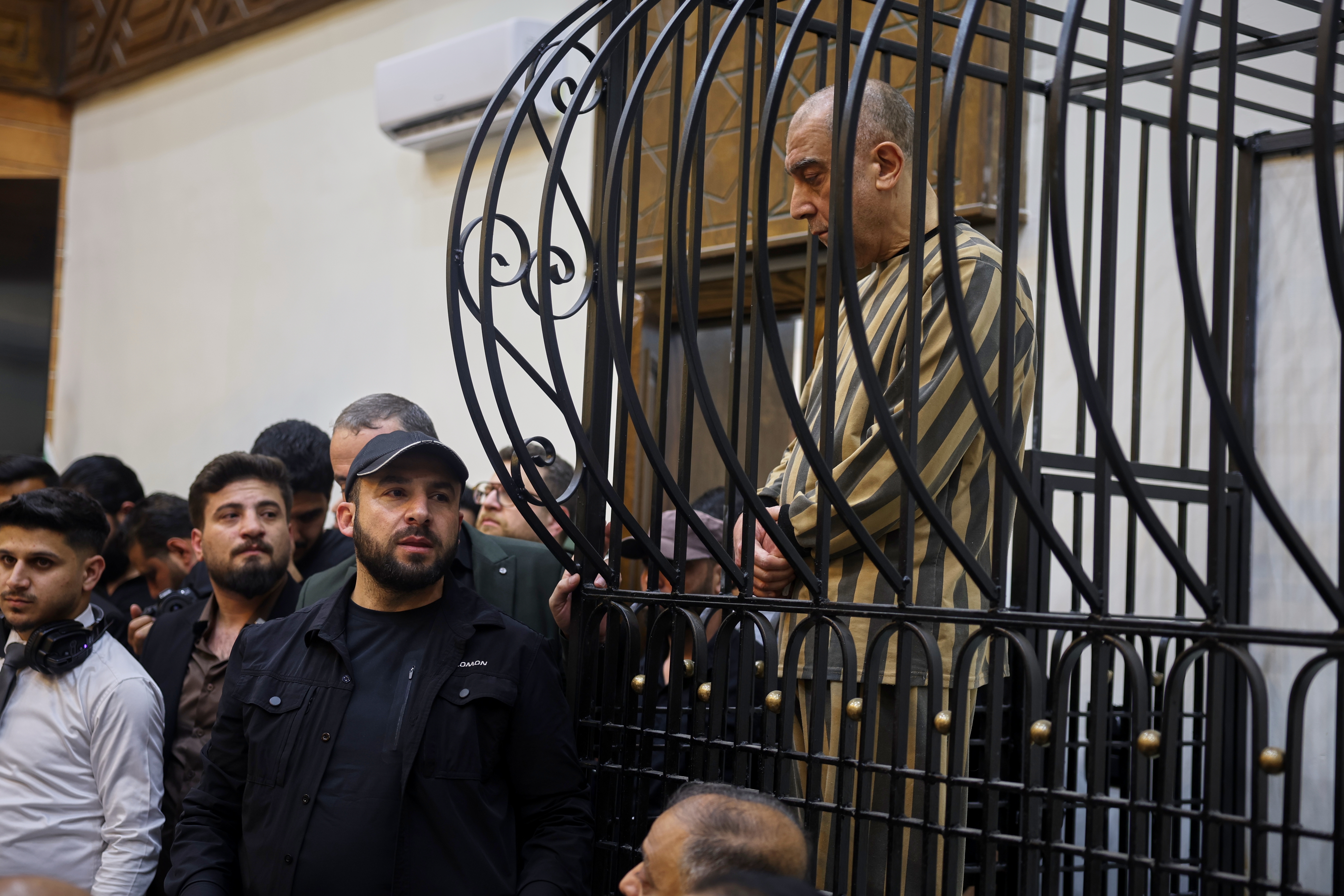 Atef Najib, former head of the Political Security Branch in the Daraa area during Bashar Assad's rule, sits in the defendants' cage during a trial session at the Palace of Justice in Damascus, Syria, April 26, 2026.