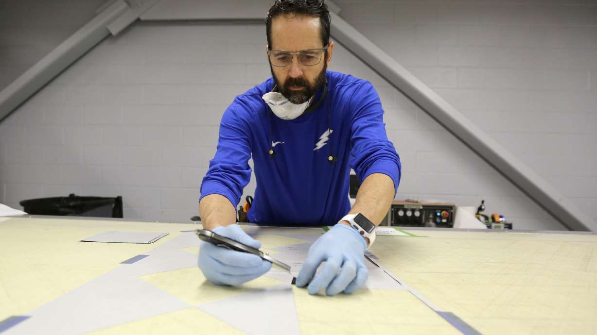 Layen Moffitt cuts carbon-fiber material for core composites at Davis Technical College in Kaysville on Jan. 29, 2020. Utah State University is expanding access to robotics and automation education through a new degree program.