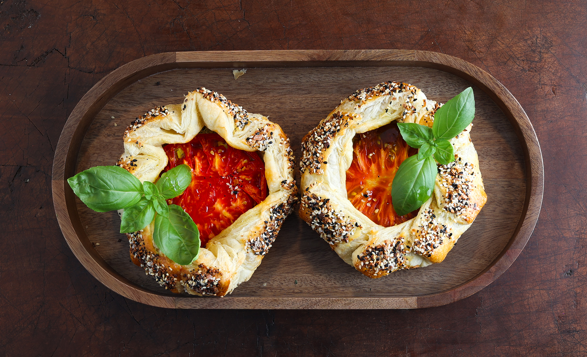 These mini tomato galettes pair flaky puff pastry with creamy, herby goat cheese and juicy heirloom tomatoes, and they look as good as they taste!
