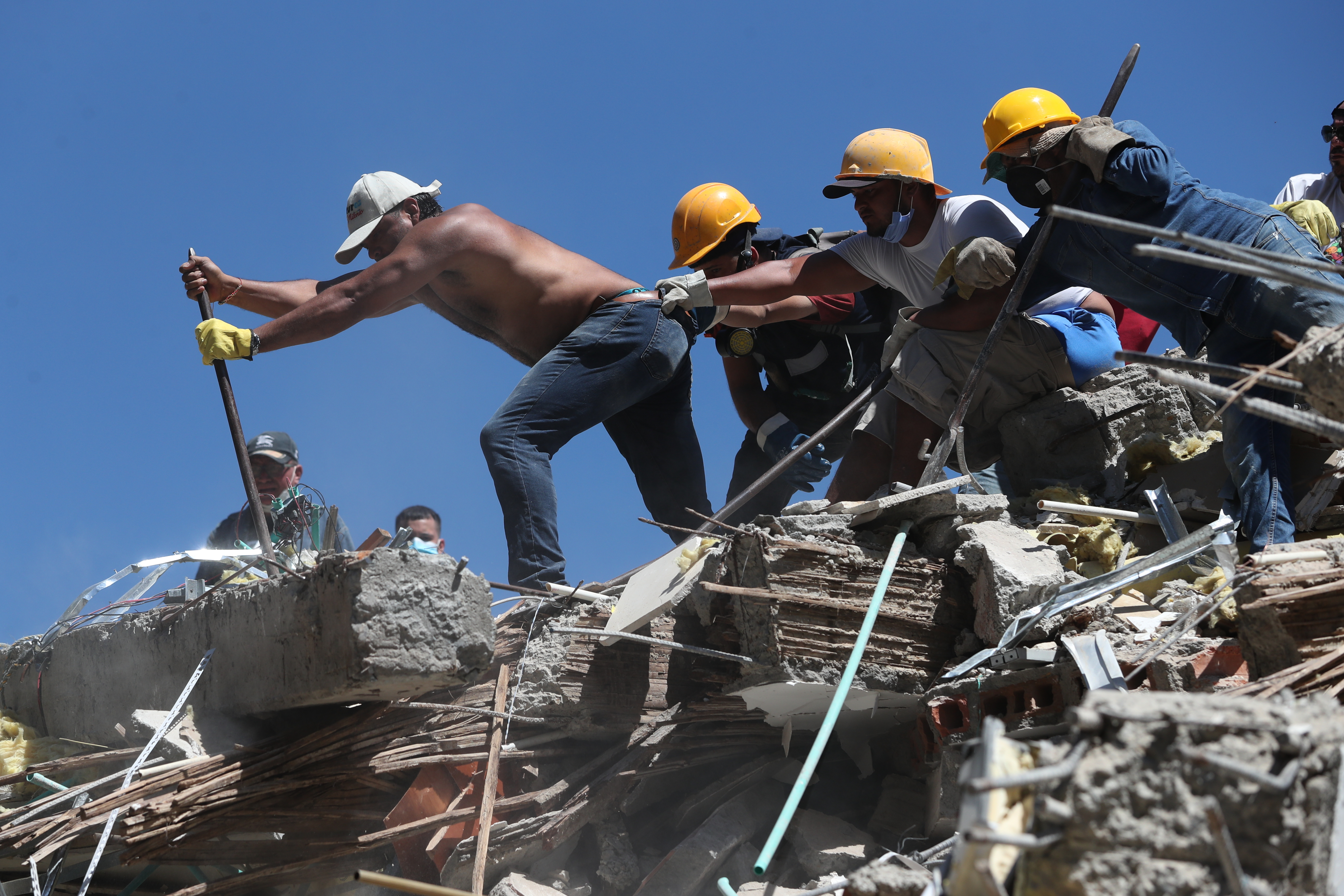Residents and rescue workers search through the rubble after an earthquake struck Cali, Colombia, on Monday. At least 181 people have been killed as of Tuesday.