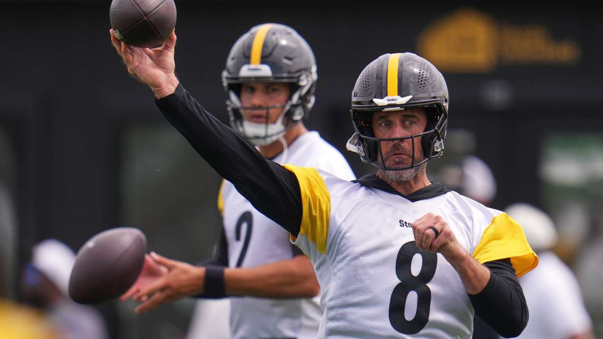 Pittsburgh Steelers quarterbacks Aaron Rodgers (8) and Mason Rudolph (2) run a drill during the NFL team's training camp in Latrobe, Pa., Saturday, Aug. 1, 2026.