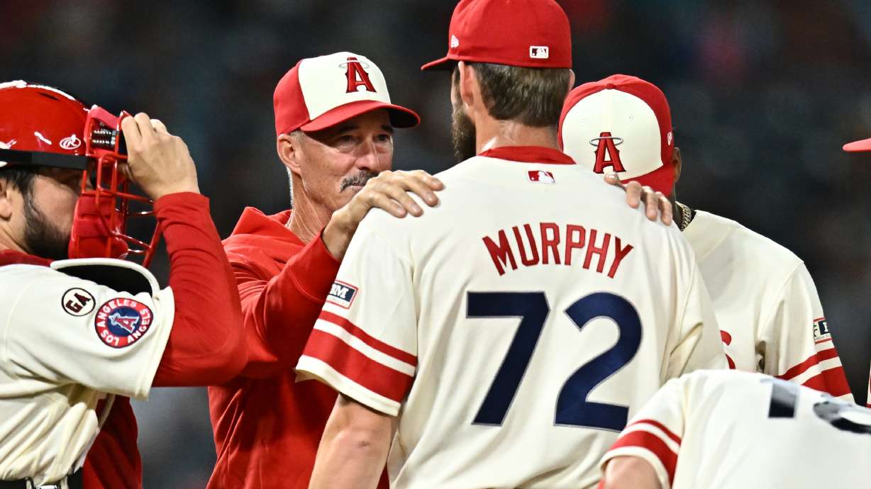 Los Angeles Angels pitcher Luke Murphy (72) speaks with pitching coach Mike Maddux, second from left, during the eighth inning of a baseball game against the Milwaukee Brewers, Friday, July 31, 2026, in Anaheim, Calif.