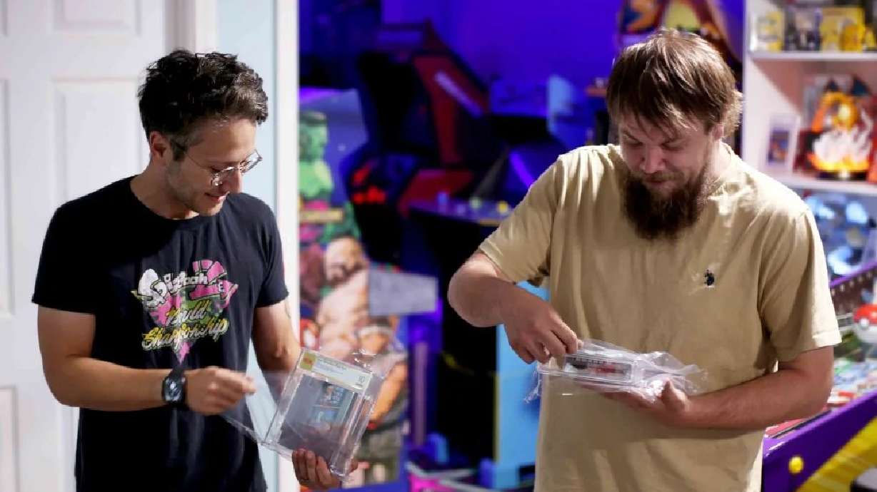 In this photo provided by Nintendo Wire, publisher Jason Ganos, left, and OneStopWonders store owner Kevin Braun hold PSA graded copies of Super Mario Bros. and Duck Hunt video games on Wednesday, June 17, which they rediscovered in a warehouse in Waukesha, Wis.