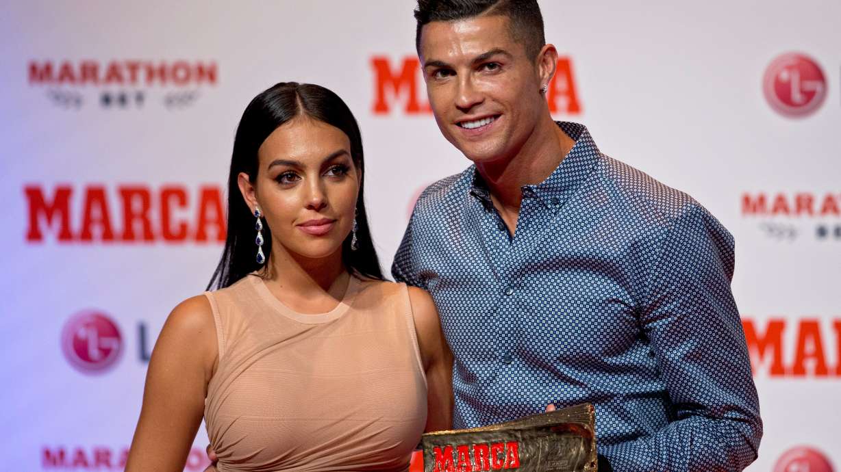 FILE - Juventus soccer player Cristiano Ronaldo poses with his partner, model Georgina Rodriguez in Madrid, July 29, 2019.
