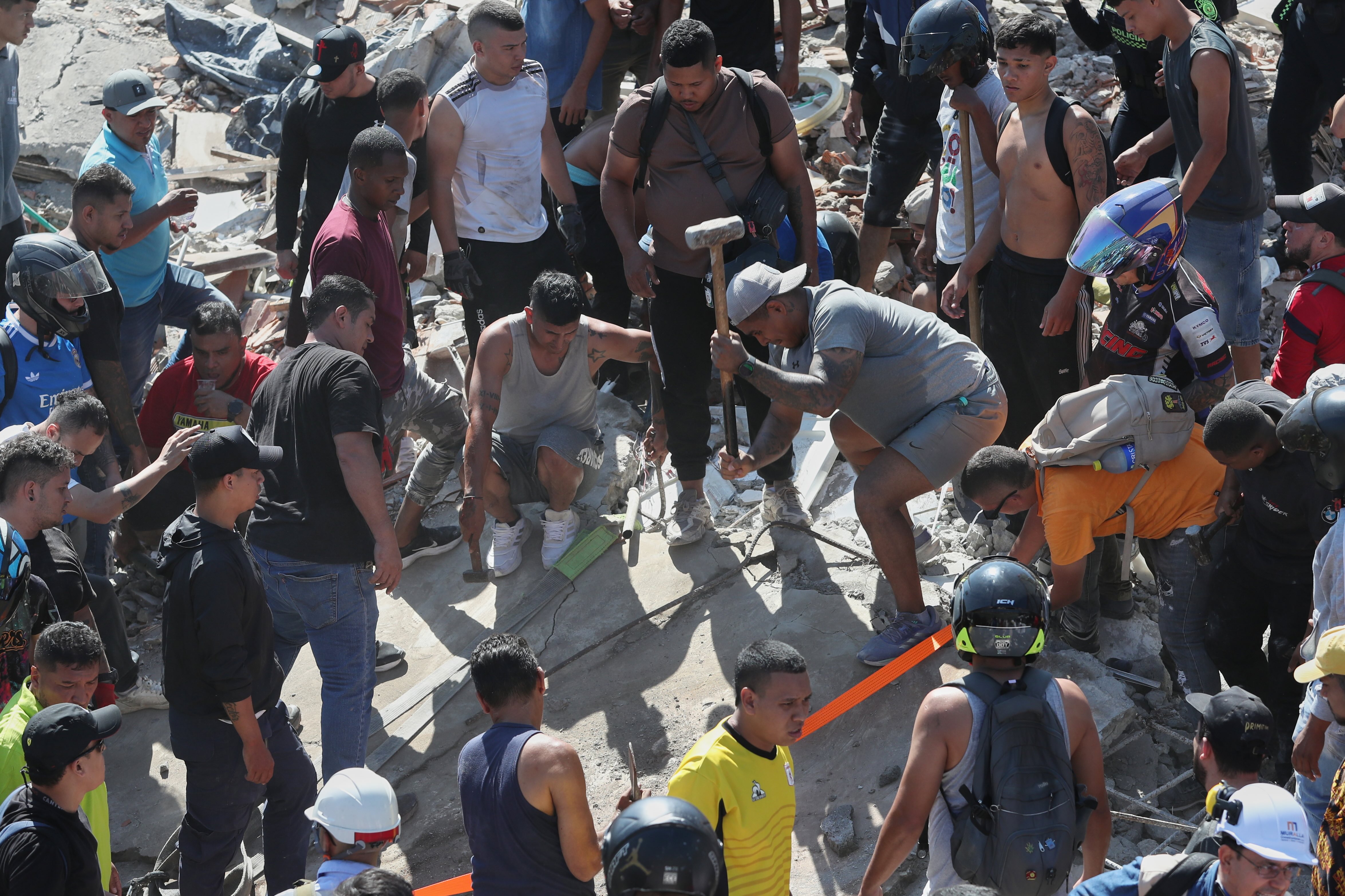 Residents search for survivors in the rubble after an earthquake struck Cali, Colombia, on Monday.