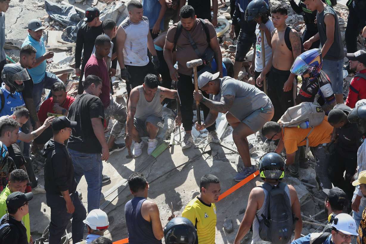 Residents search for survivors in the rubble after an earthquake struck Cali, Colombia, on Monday.