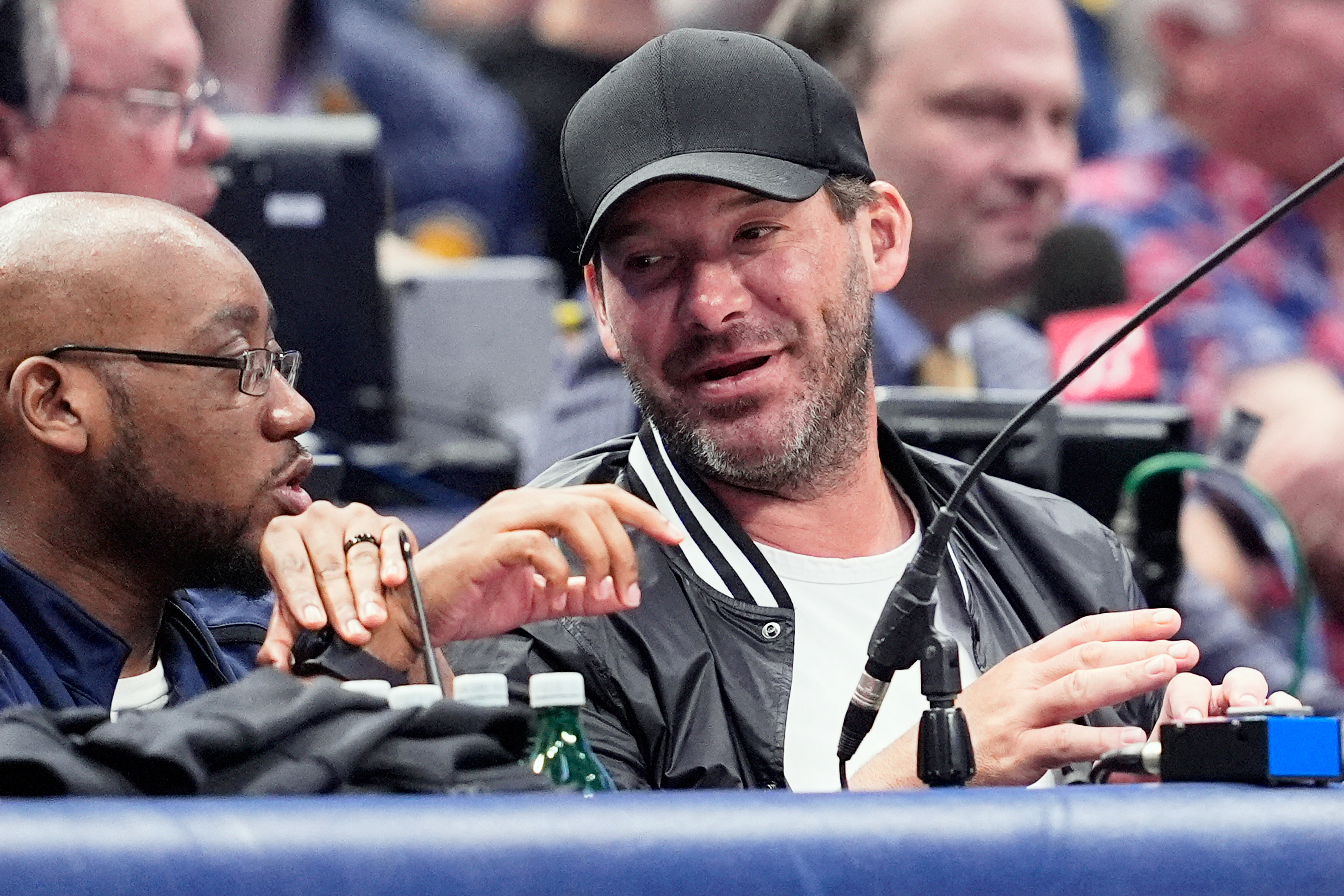 FILE - Former NFL quarterback Tony Romo, right, attends an NBA basketball game between the Indiana Pacers and the Dallas Mavericks on March 5, 2024, in Dallas. 