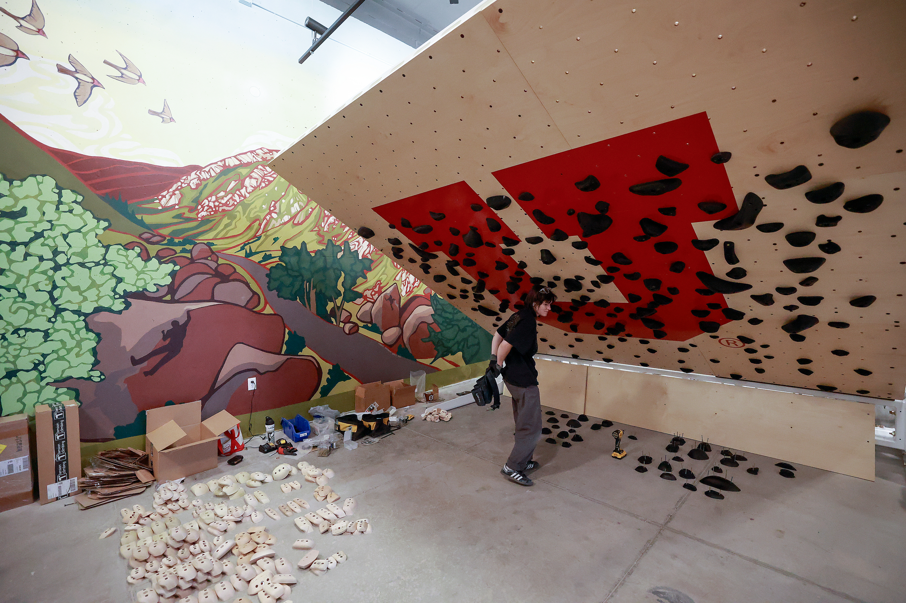 Haley Pierce, route setter, installs a climbing wall in Trailhead, the University of Utah’s newest residence hall, in Salt Lake City on Tuesday. The U. this semester will welcome students to the new 1,447-bed residence hall.