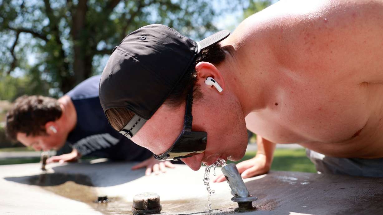 Nick Sylvester takes a break from running to drink water at Liberty Park during a heat wave in Salt Lake City on July 13. Last month was Utah's second-warmest July on record, but also its 31st-wettest.
