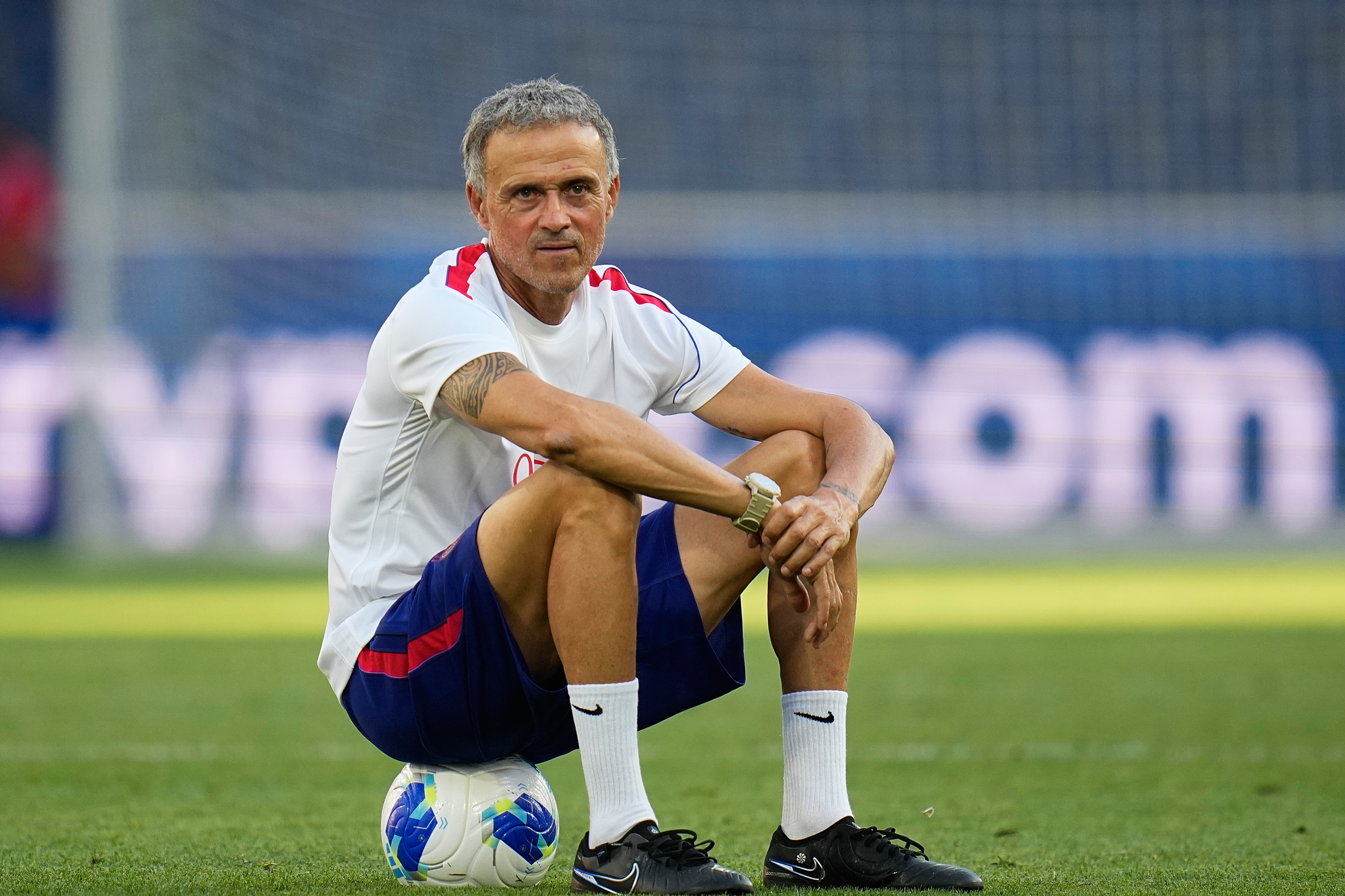 PSG's head coach Luis Enrique sits on a ball during a training session ahead of the UEFA Super Cup soccer match against Aston Villa in Salzburg, Austria, Tuesday, Aug. 11, 2026. 