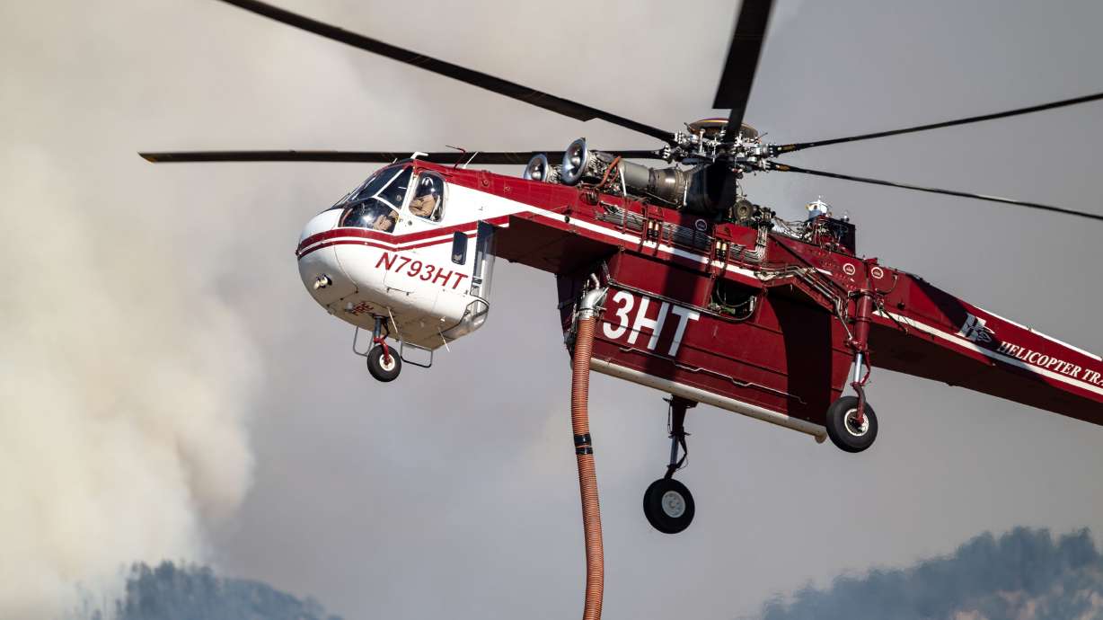A Sikorsky Skycrane approaches to refill as crews fight the Widemouth 2 Fire east of Fillmore, on Aug. 4. Utah's congressional and local leaders paid tribute to the firefighters who died fighting the Widemouth 2 Fire last week.