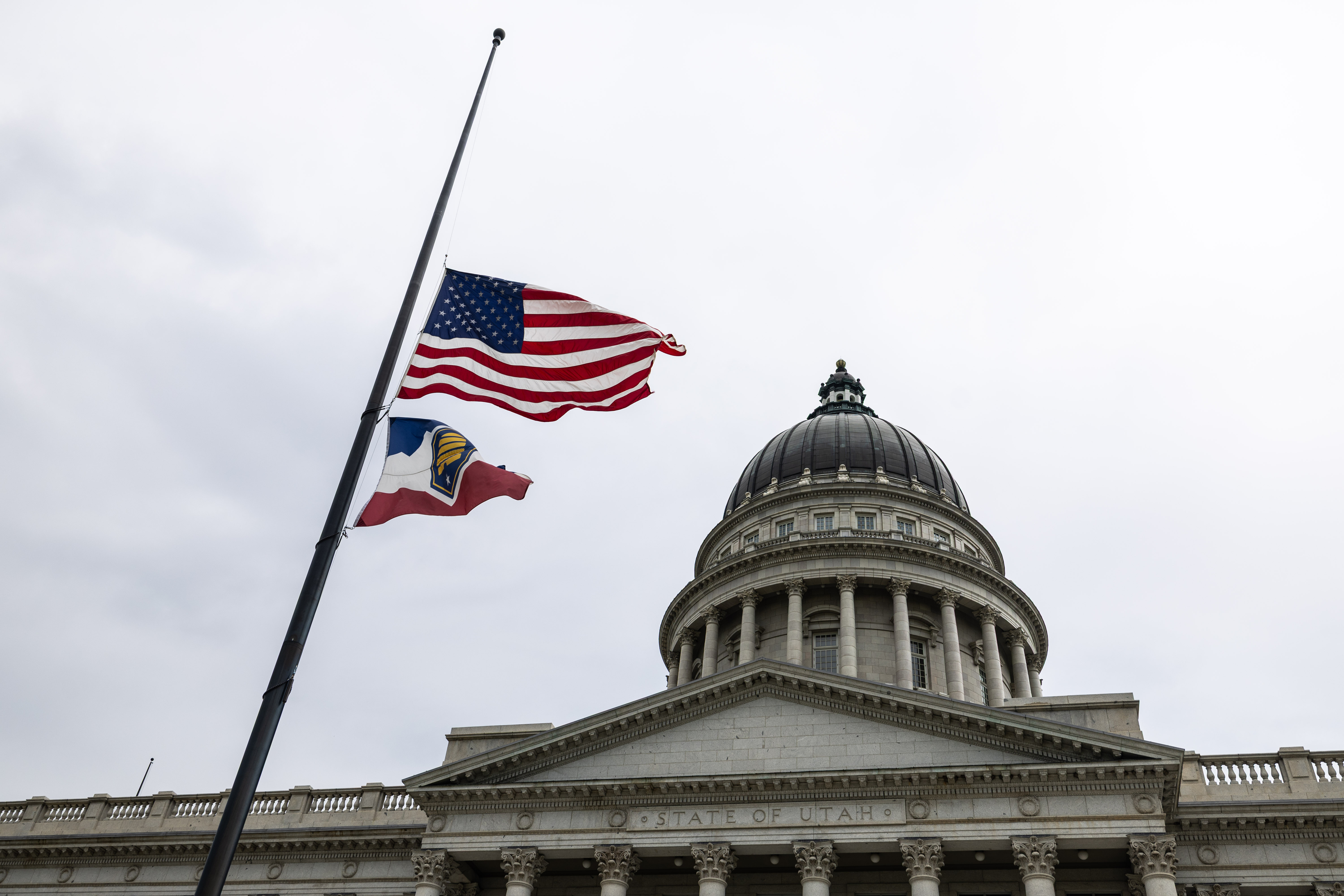 Flags in front of the Capitol fly at half-staff in Salt Lake City on Tuesday. The flags were lowered in honor of firefighter pilots Chris Andersen and Miles Elliott, who died in the line of duty while battling the Widemouth 2 Fire in Utah.
