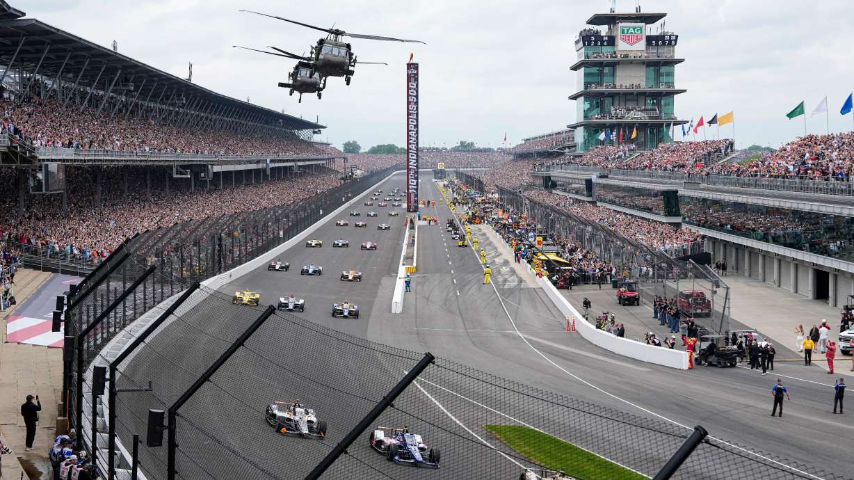 FILE - Helicopters fly over the field on the parade lap before the Indianapolis 500 auto race in Indianapolis, May 24, 2026.