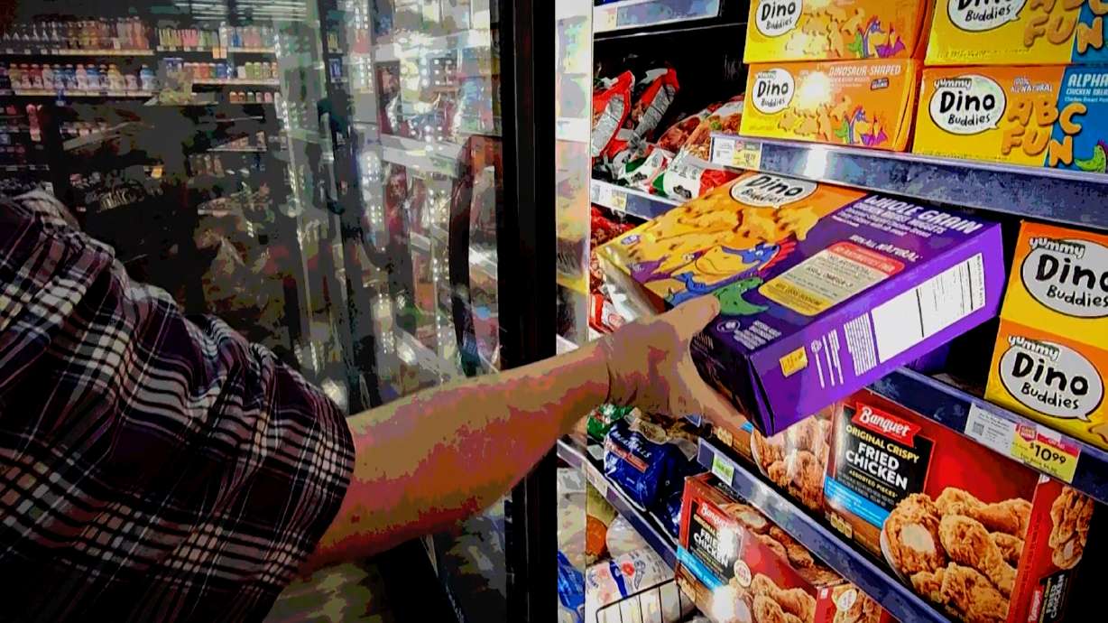 A shopper reaches for a frozen food item at a Utah grocery store. A new survey found 30% of American adults say they have shoplifted.
