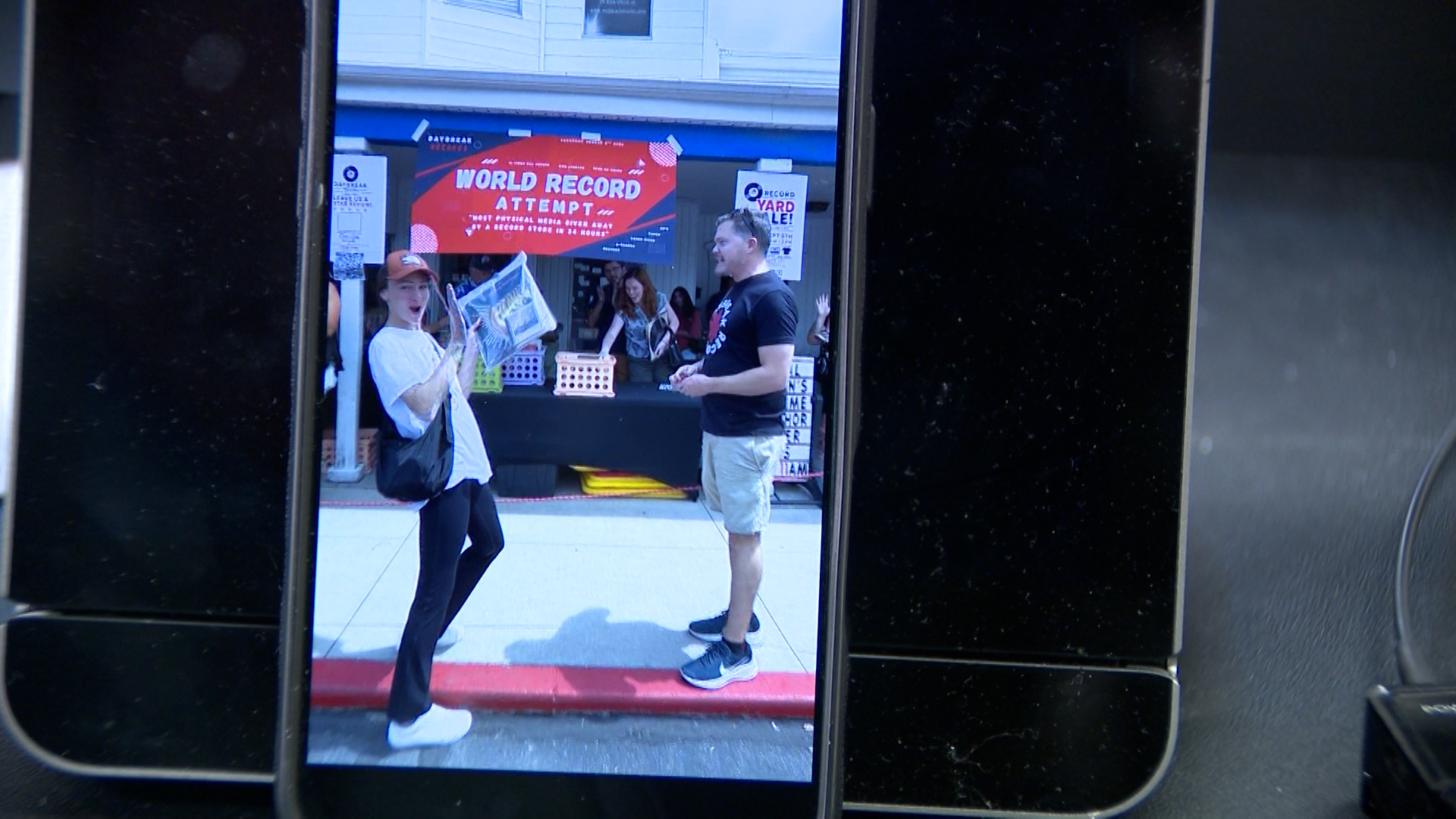 Daybreak Records owner David Paul is pictured the moment his shop broke the record for the most physical media given away by a record store in 24 hours.
