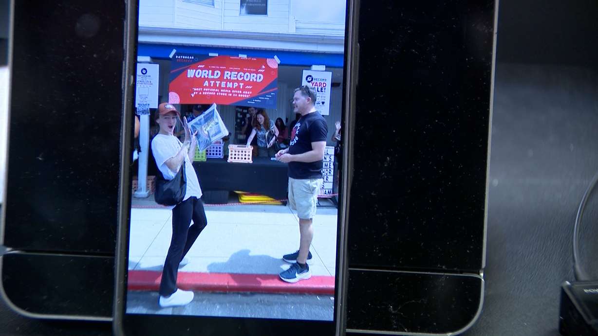 Daybreak Records owner David Paul is pictured the moment his shop broke the record for the most physical media given away by a record store in 24 hours.