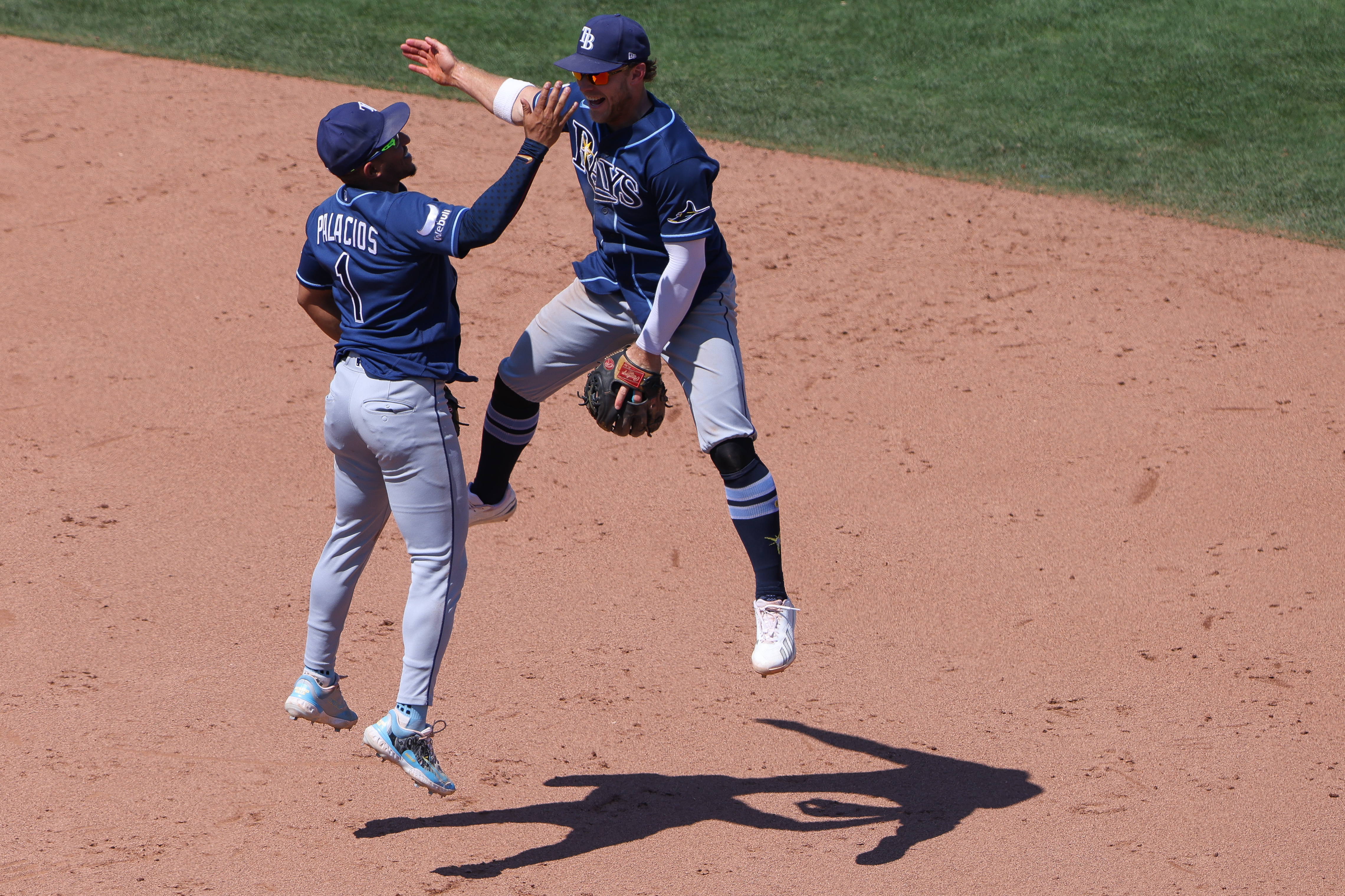Tampa Bay Rays' Richie Palacios (1) and Taylor Walls, right, celebrate after the final out of a baseball game as the Rays defeat the Athletics Wednesday, Aug. 12, 2026, in West Sacramento, Calif. 