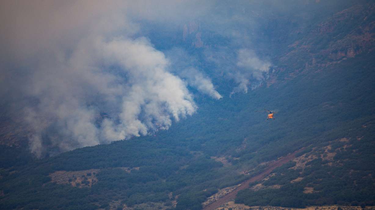 A firefighting helicopter moves toward the Rocky Canyon Fire in Henefer on Tuesday. Utah's percentage of human-caused fires has dropped over the past two months, but the fire is an example of the threat that still exists.