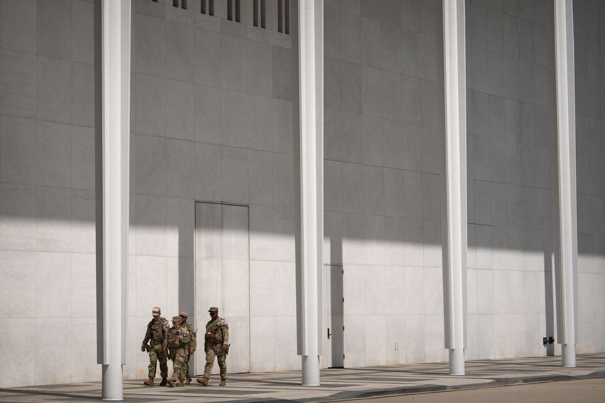 National Guard members walk outside of the Kennedy Center, July 31, in Washington. The center has become a visible symbol of presidential power.