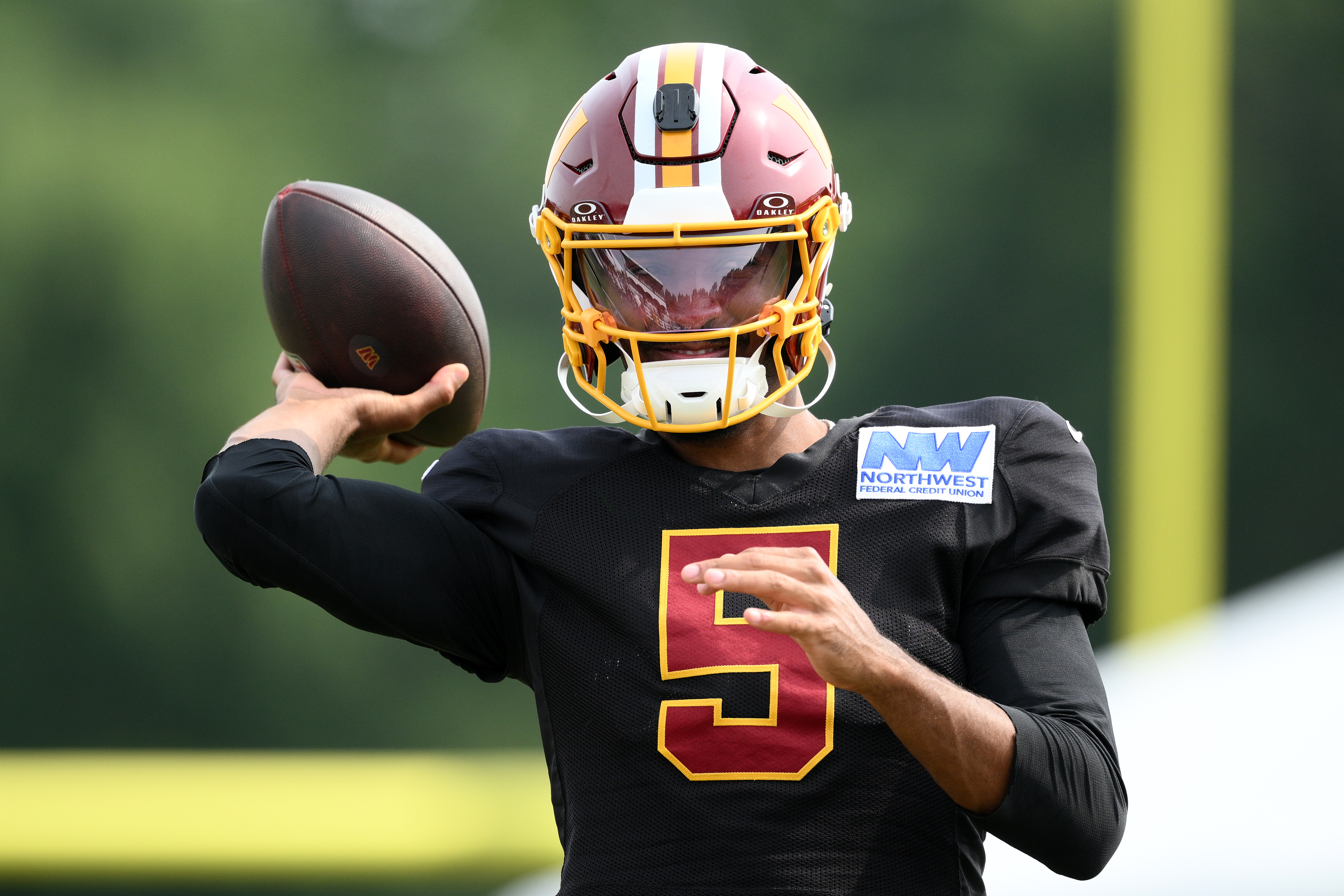 Washington Commanders quarterback Jayden Daniels works out before a joint practice with the Miami Dolphins at NFL football training camp, Wednesday, Aug. 12, 2026 in Ashburn, Va. 