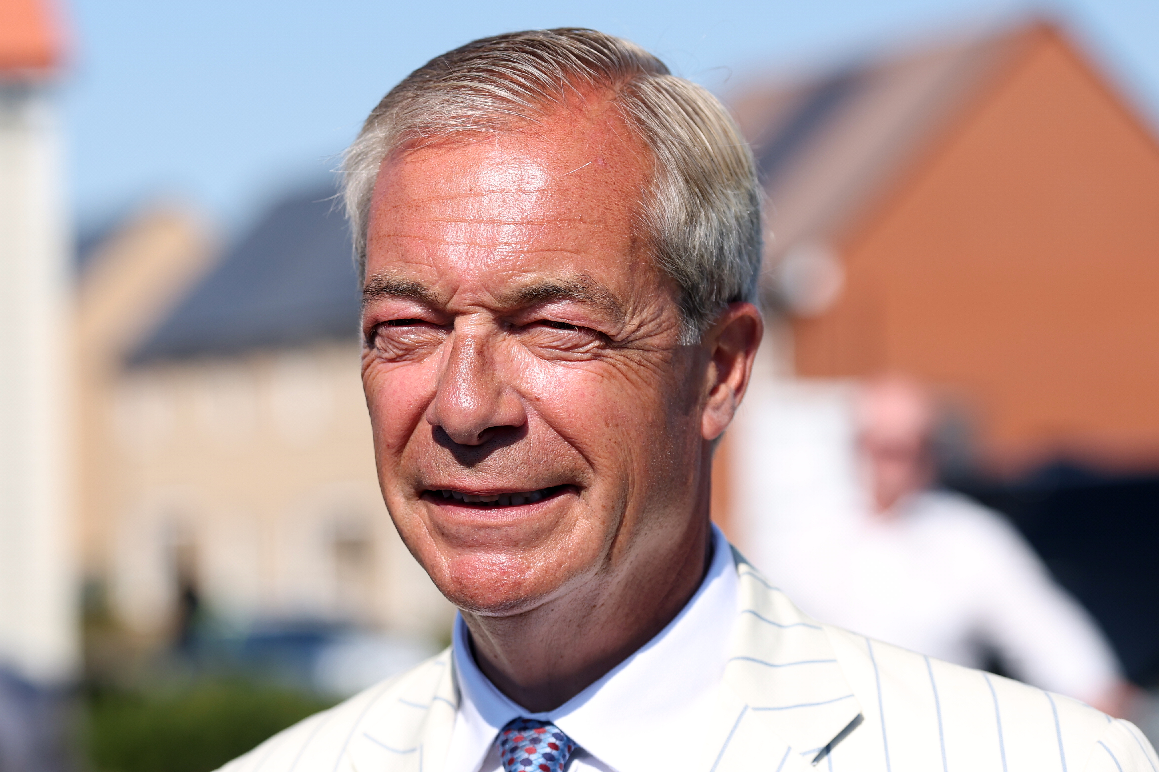 Britain's Reform UK party leader Nigel Farage arrives at a polling station in Walton on the Naze, Thursday, to cast his vote for the Clacton on Sea by-election. Farage's opponents denounced the election as a stunt.