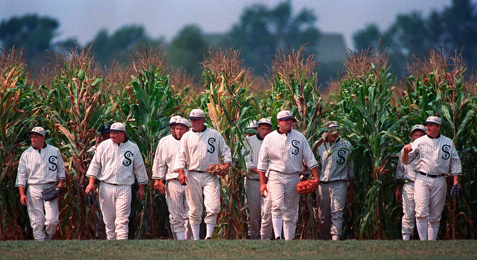 FILE - People portraying ghost players emerge from the cornfield at the "Field of Dreams" movie site in Dyersville, Iowa, on June 22, 1997. 