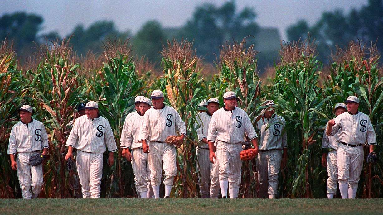 FILE - People portraying ghost players emerge from the cornfield at the "Field of Dreams" movie site in Dyersville, Iowa, on June 22, 1997.