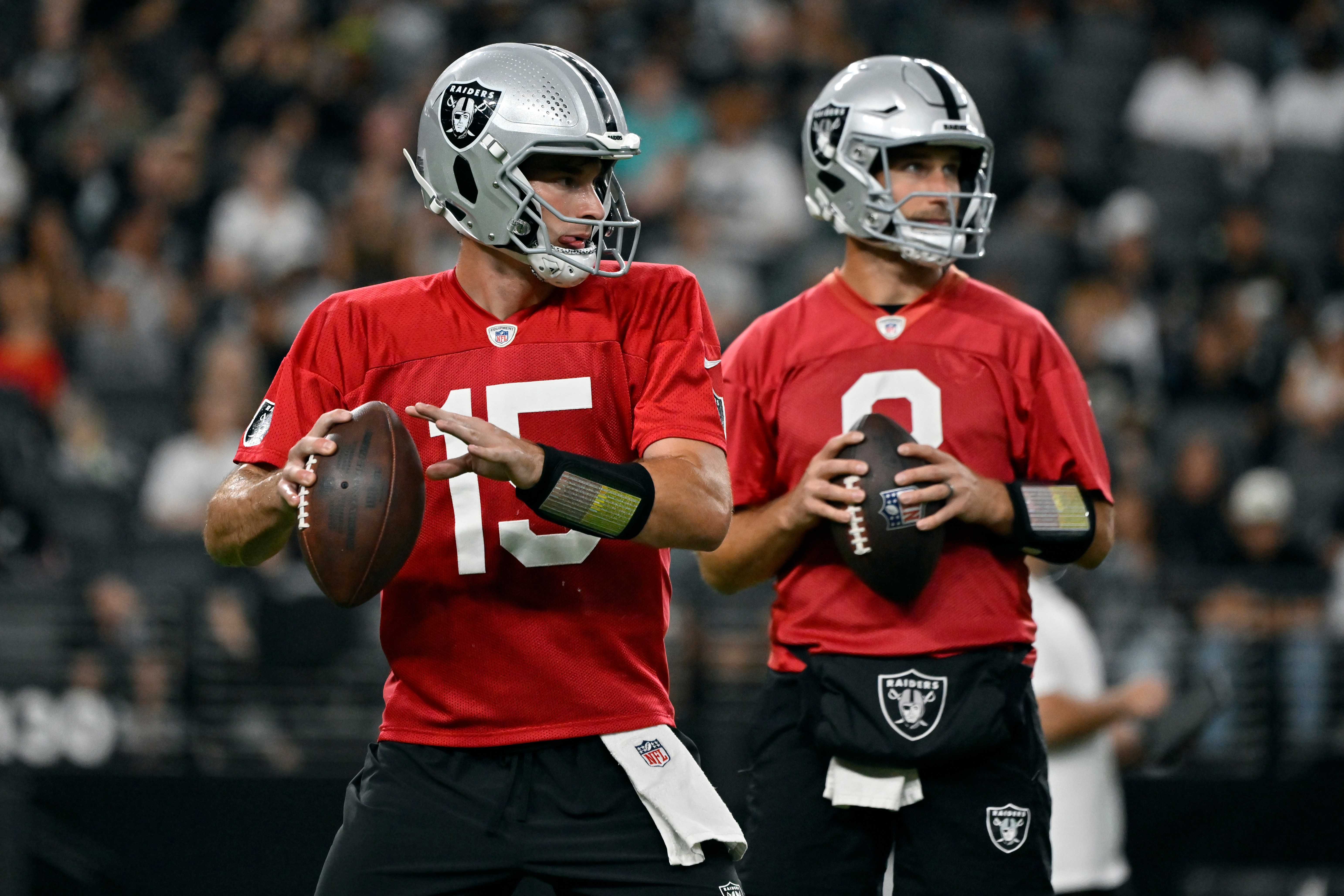 Las Vegas Raiders quarterbacks Fernando Mendoza (15) and Kirk Cousins (8) participate during an NFL football practice Tuesday, Aug. 11, 2026, in Las Vegas. 