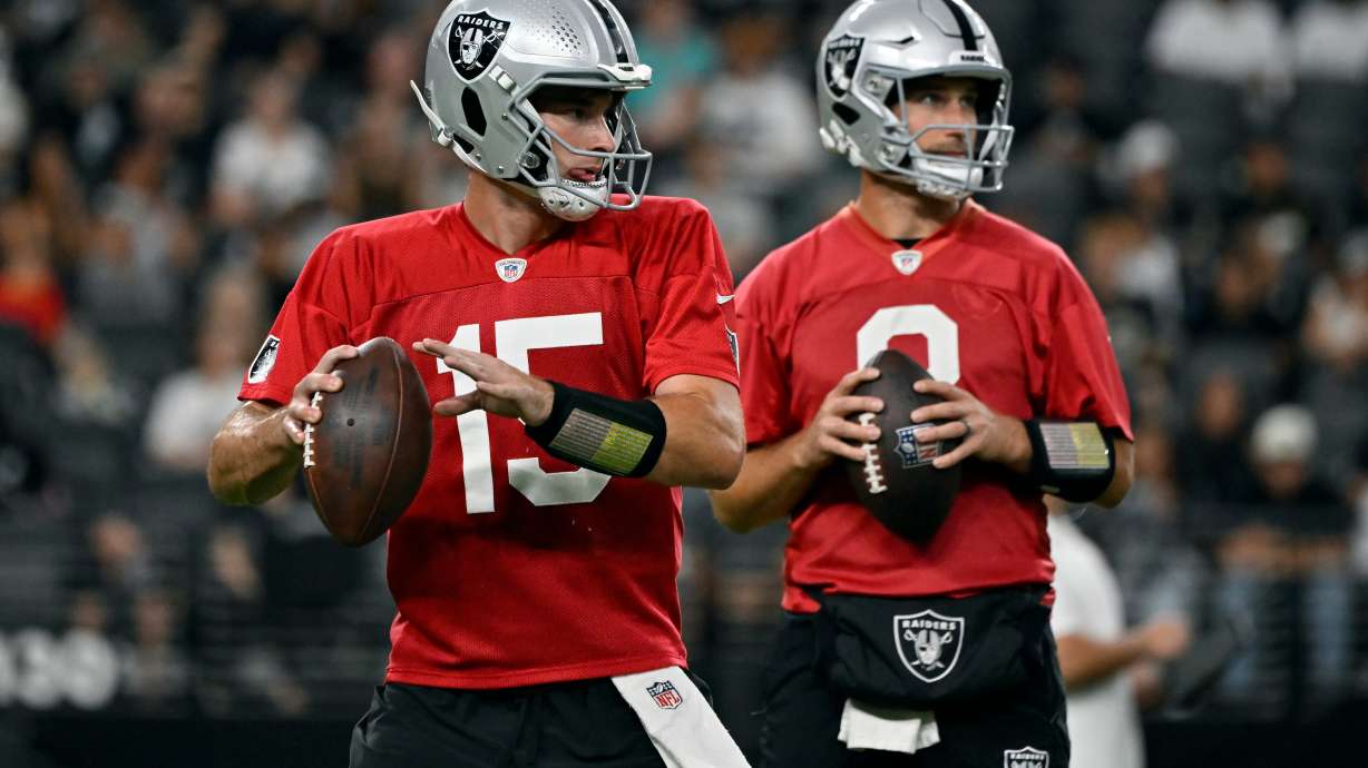 Las Vegas Raiders quarterbacks Fernando Mendoza (15) and Kirk Cousins (8) participate during an NFL football practice Tuesday, Aug. 11, 2026, in Las Vegas.