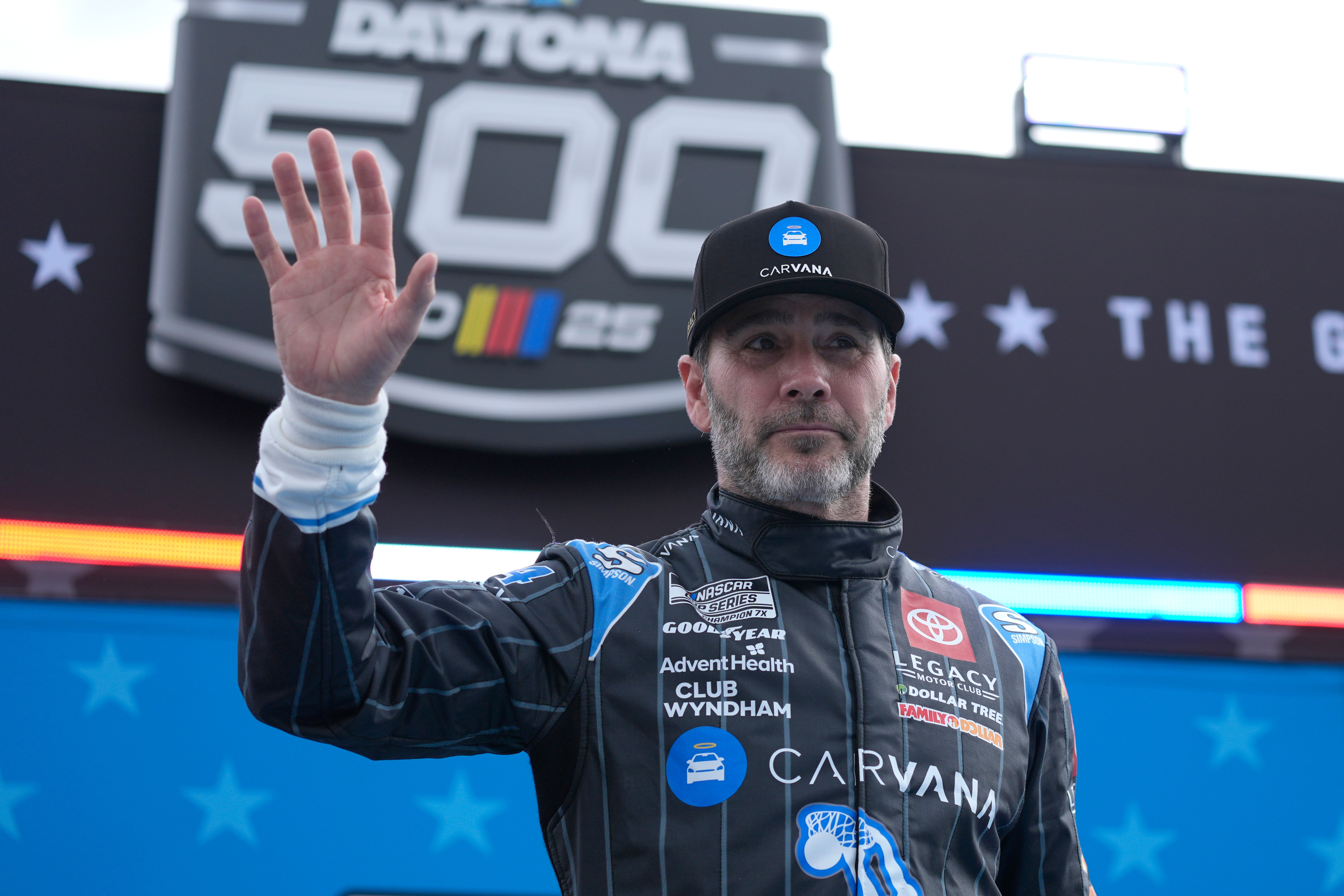 FILE - Jimmie Johnson waves during driver introductions before the NASCAR Daytona 500 auto race at Daytona International Speedway, Feb. 16, 2025, in Daytona Beach, Fla. 