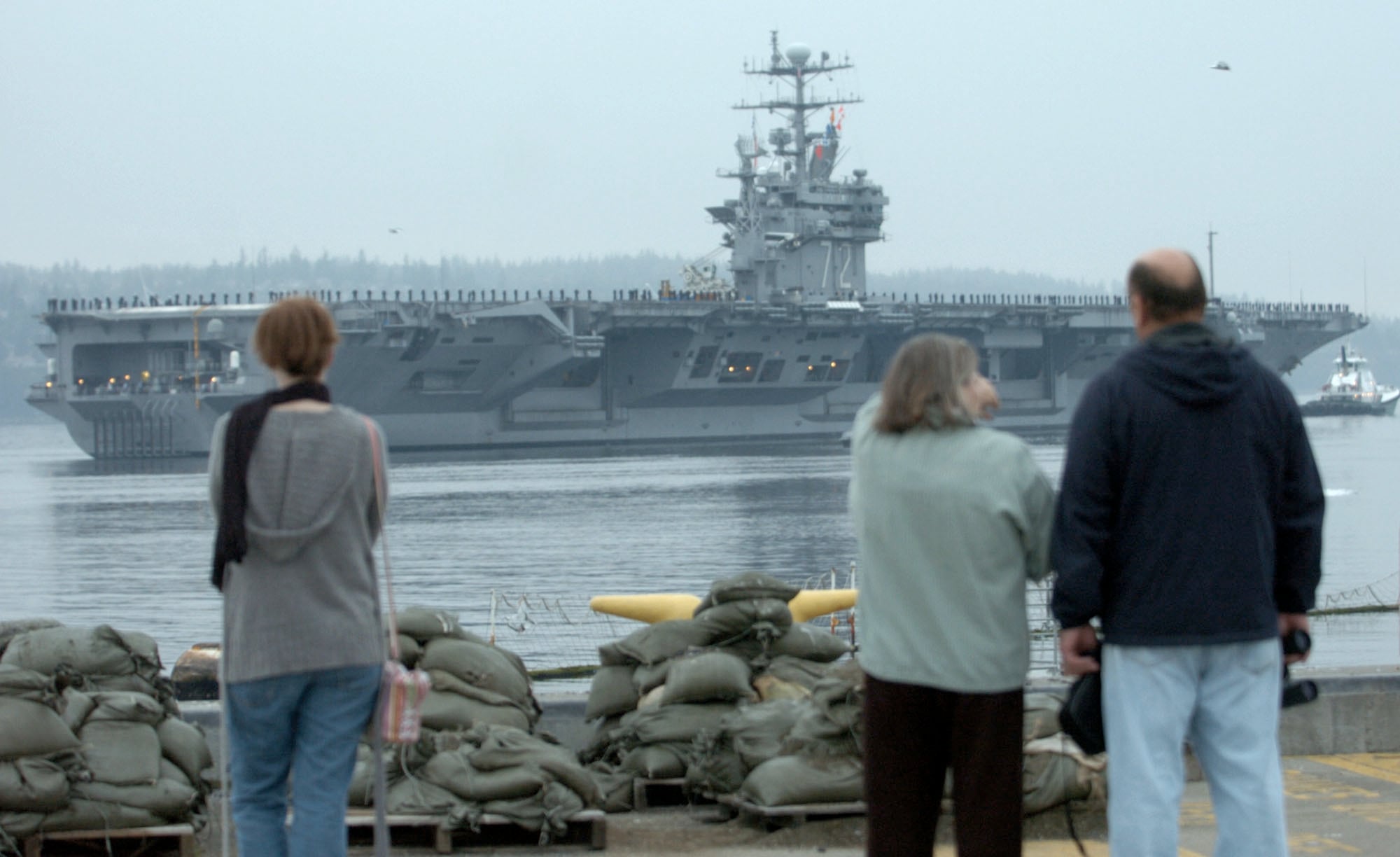 Family and friends gather to watch the USS Abraham Lincoln as it leaves Naval Station Everett in Washington state, Friday, Oct. 15, 2004.
