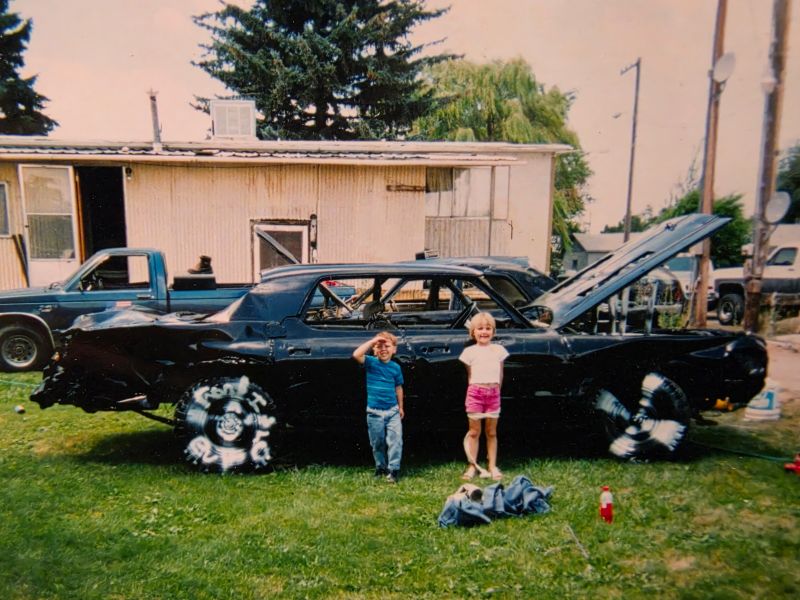 A girl and boy pose in front of a future Eastern Idaho State Fair demolition derby car in this undated photo. The girl would later grow up to drive that same car in the Powder Puff Derby, showing the derby is a family affair.