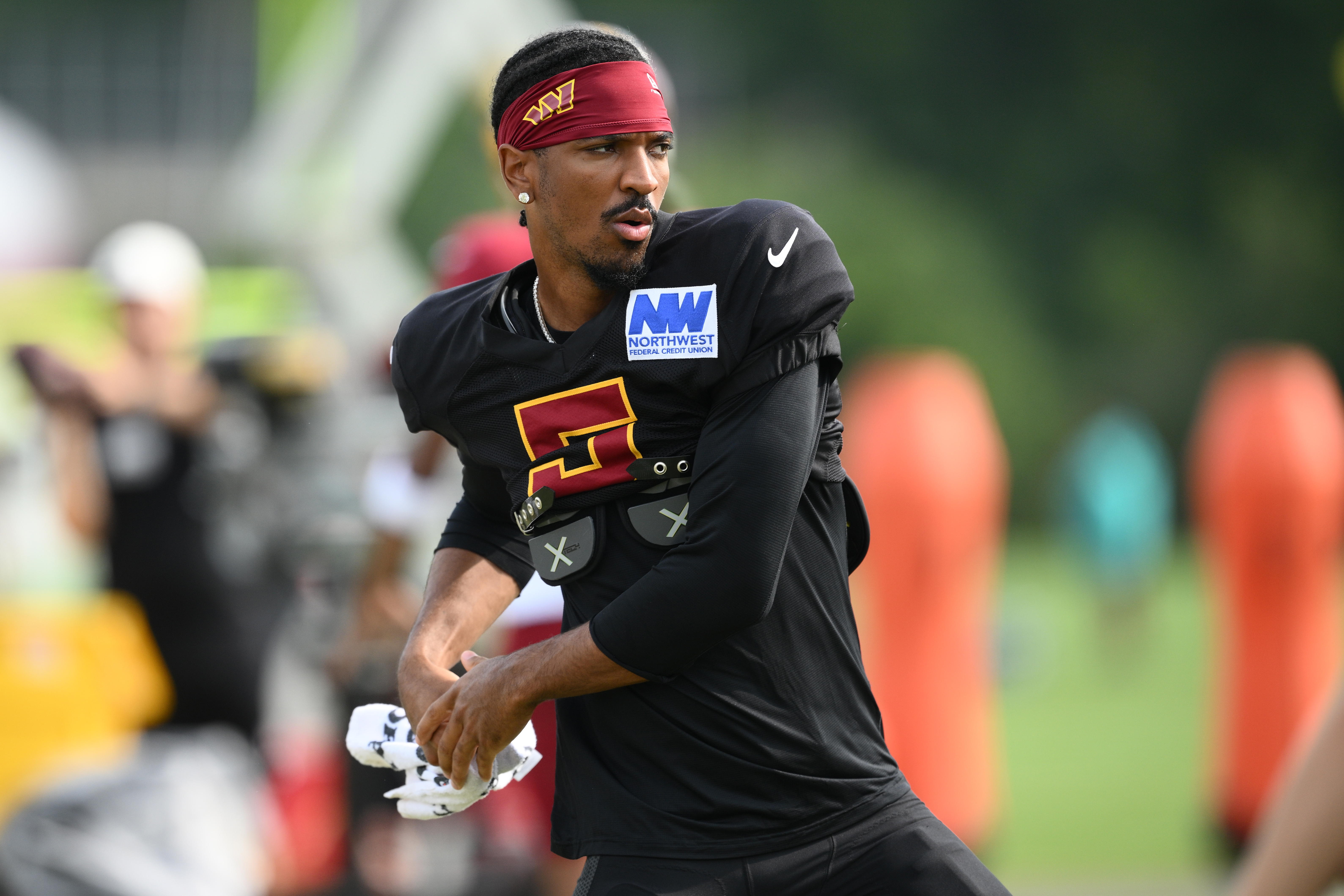 Washington Commanders quarterback Jayden Daniels works out before a joint practice with the Miami Dolphins at NFL football training camp, Wednesday, Aug. 12, 2026 in Ashburn, Va. 