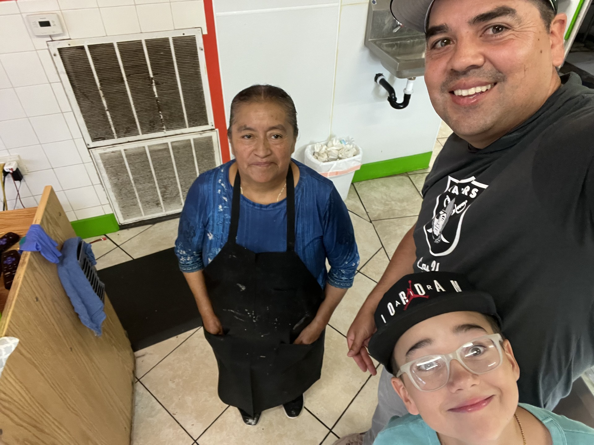 Jake Palma and son Carson are on a whirlwind trip around Utah, trying Mexican food in each of the state's 29 counties. They are pictured Thursday at El Patrón, an Ogden eatery, with the cook from the locale.