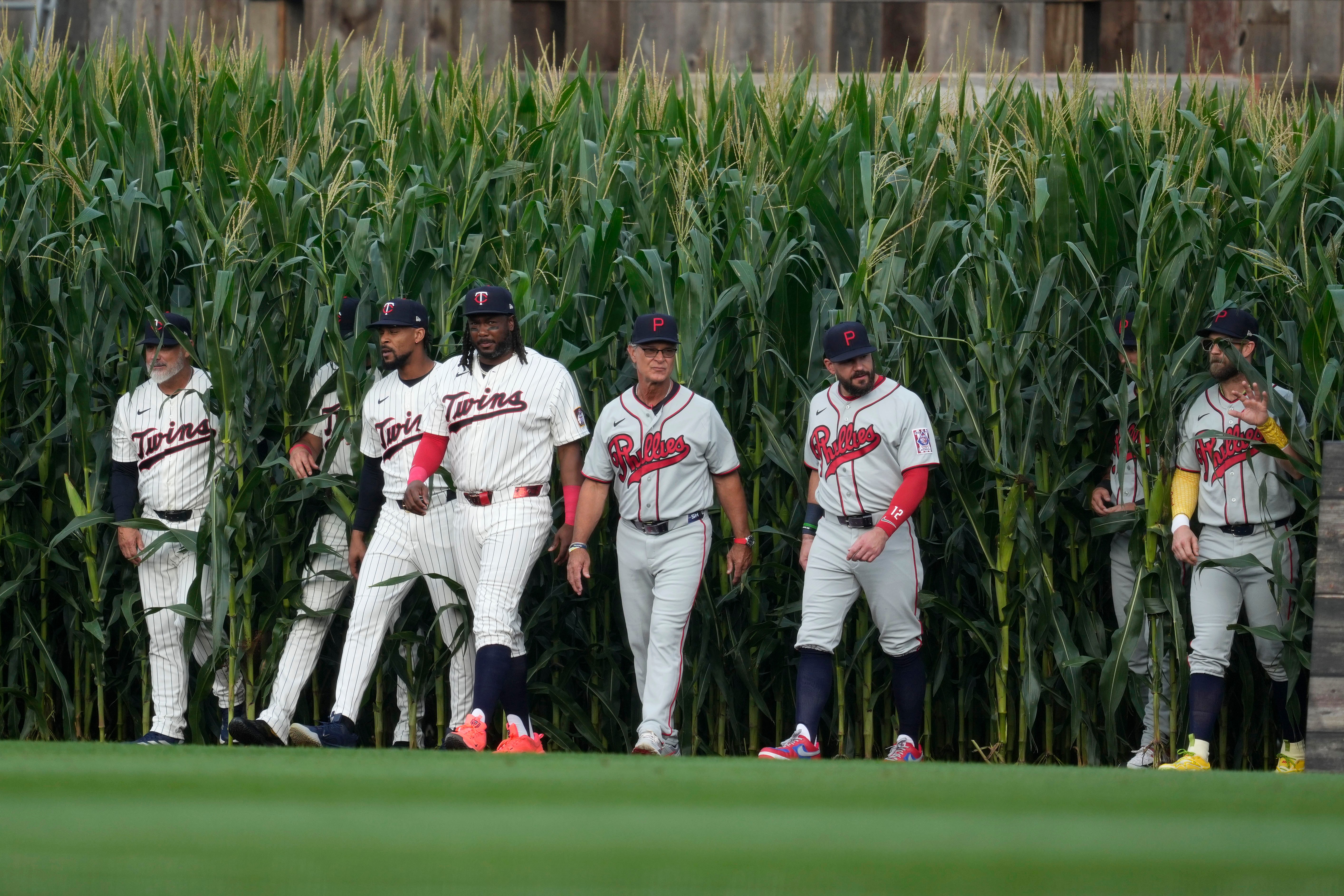 Players walk onto the field before a baseball game between the Minnesota Twins and the Philadelphia Phillies at the Field of Dreams movie site, Thursday, Aug. 13, 2026, in Dyersville, Iowa. 